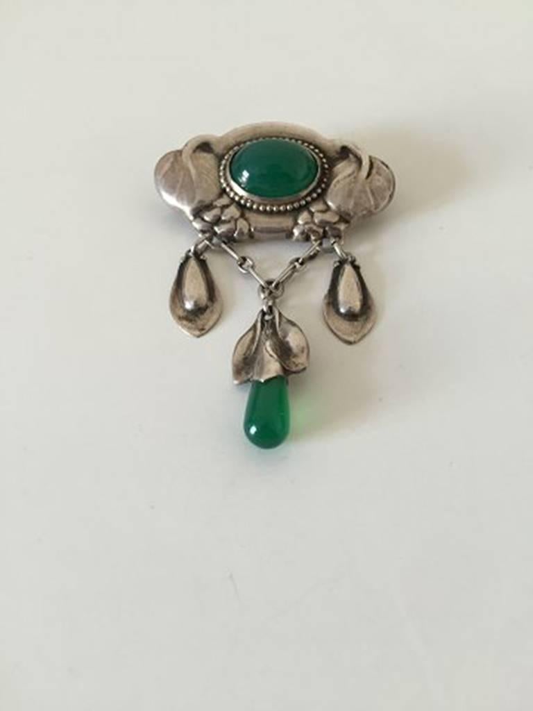 Early Evald Nielsen Silver Brooch with Green Stones. Measures 6.7 cm x 4.5 cm / 2 41/64 in x 1 49/64 in and is in good condition. Weighs 16.9 g / 0.59 oz
