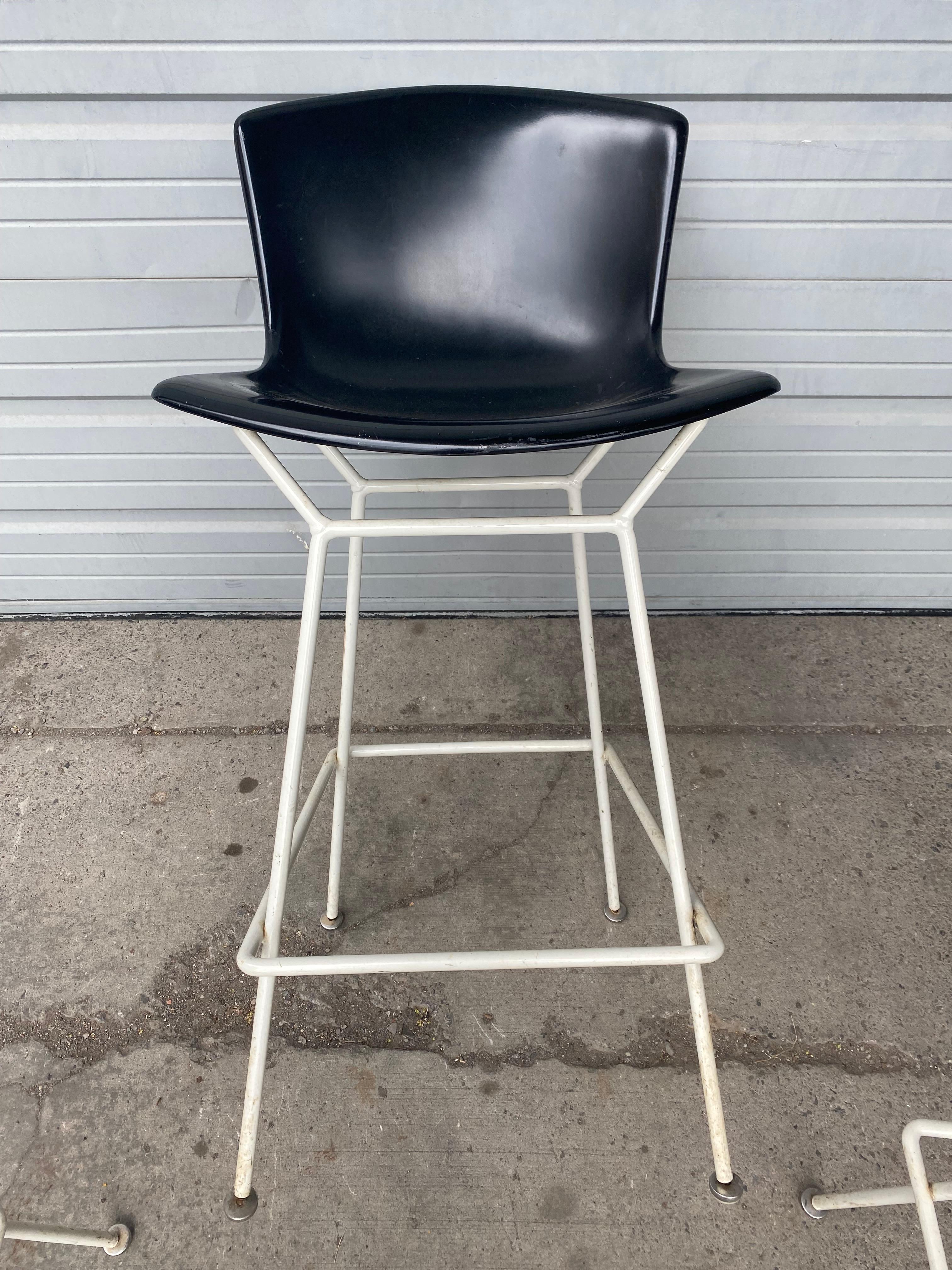 Early fiberglass shell and metal Bertoia bar stools, Harry Bertoia for Knoll, structurally sound, wear to original black molded fiberglass tops, retain original early KNOLL labels.