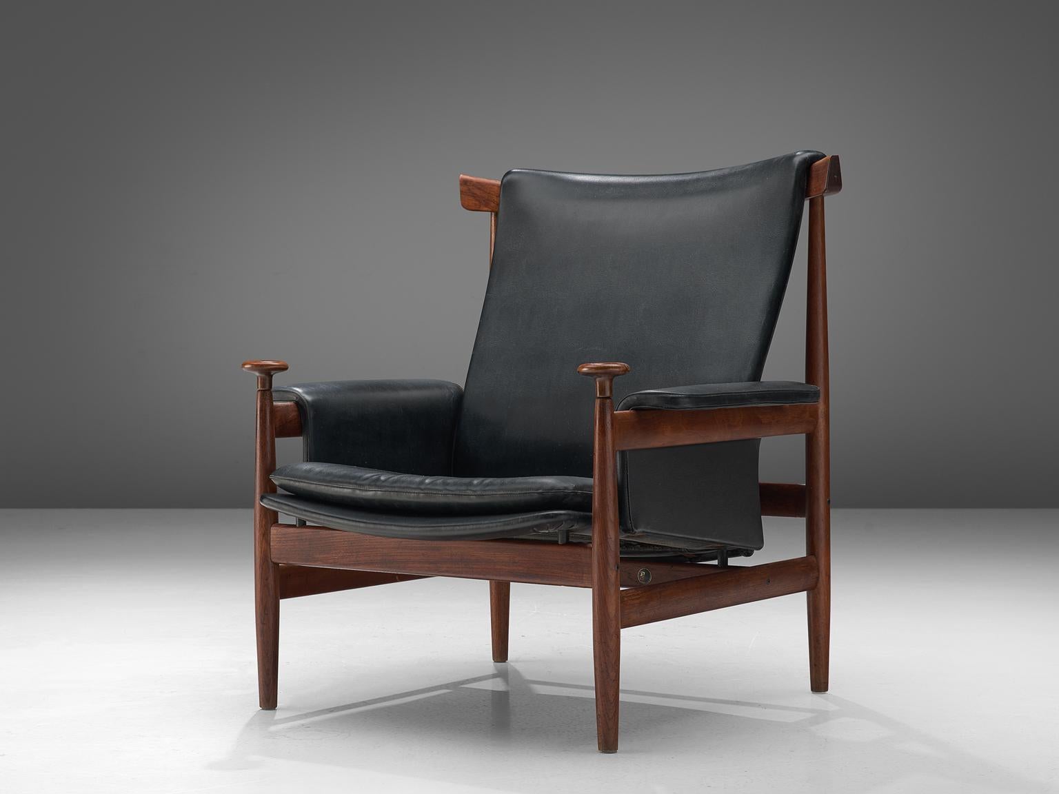 Finn Juhl for France and Son, 'Bwana' lounge chair, teak and black leather, Denmark, 1962 design, 1960s production.

This is an excellent solid teak version of Finn Juhl's 'Bwana' chair. The 