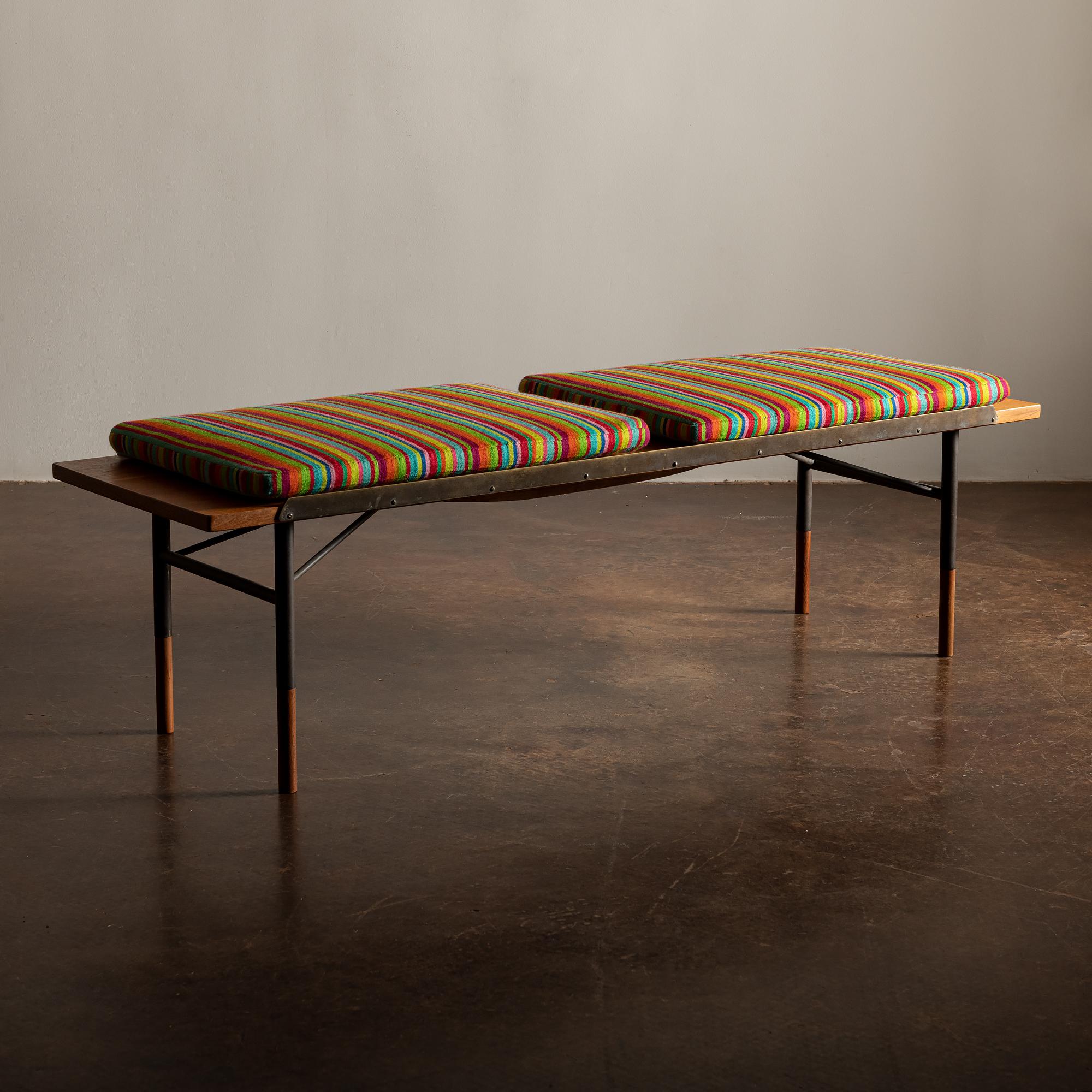 Beautiful bench designed by Finn Juhl for Bovirke in 1953 with anodized steel frame, teak seat, tall teak shoes and raised brass edges. Conceived by Juhl to be used as a bench and/or coffee table. This example manufactured by Bovirke circa 1960s.