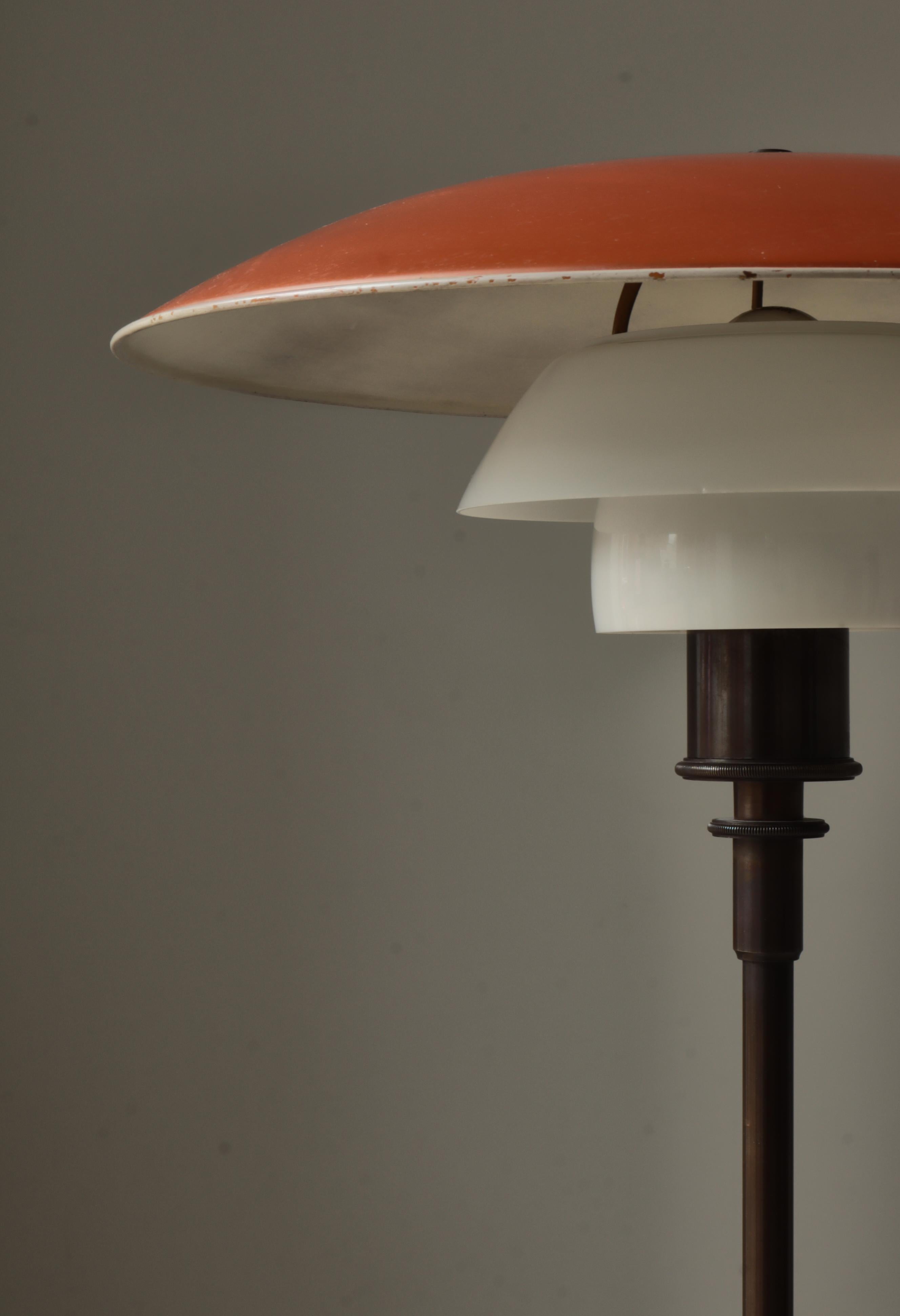 Early and important floor PH-lamp model 4/3 by Poul Henningsen manufactured at Louis Poulsen, Copenhagen between 1926-28. The lamp base is made from browned brass and the top shade is red and white lacquered copper. Middle and lower screen are