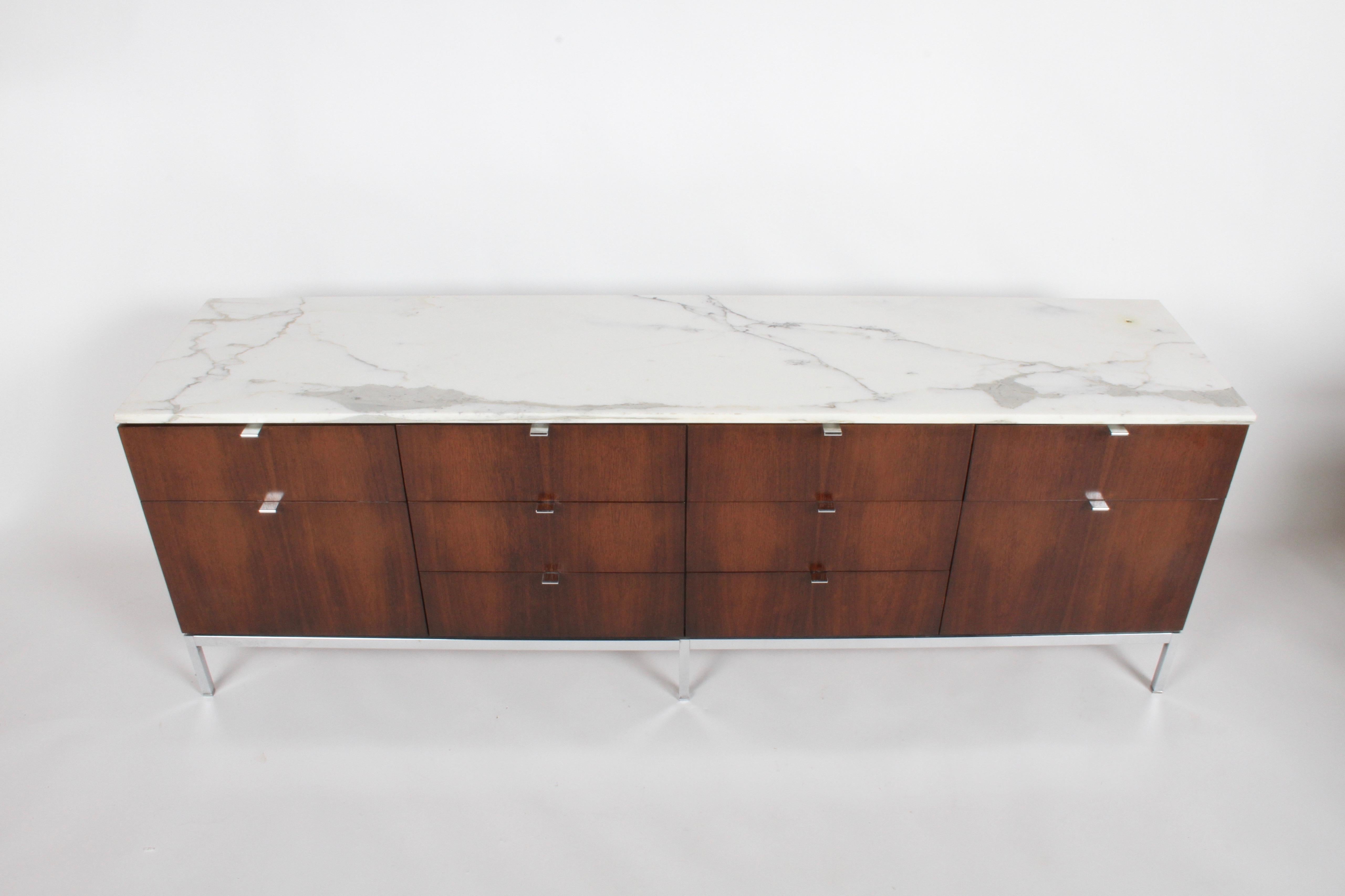 Florence Knoll credenza in rosewood, drawer fronts are book matched with beautiful Calacatta marble top. The 10 drawer Rosewood cabinet has been restored, chrome pulls and base polish, showing only light patina. Calacatta top is free of cracks, but