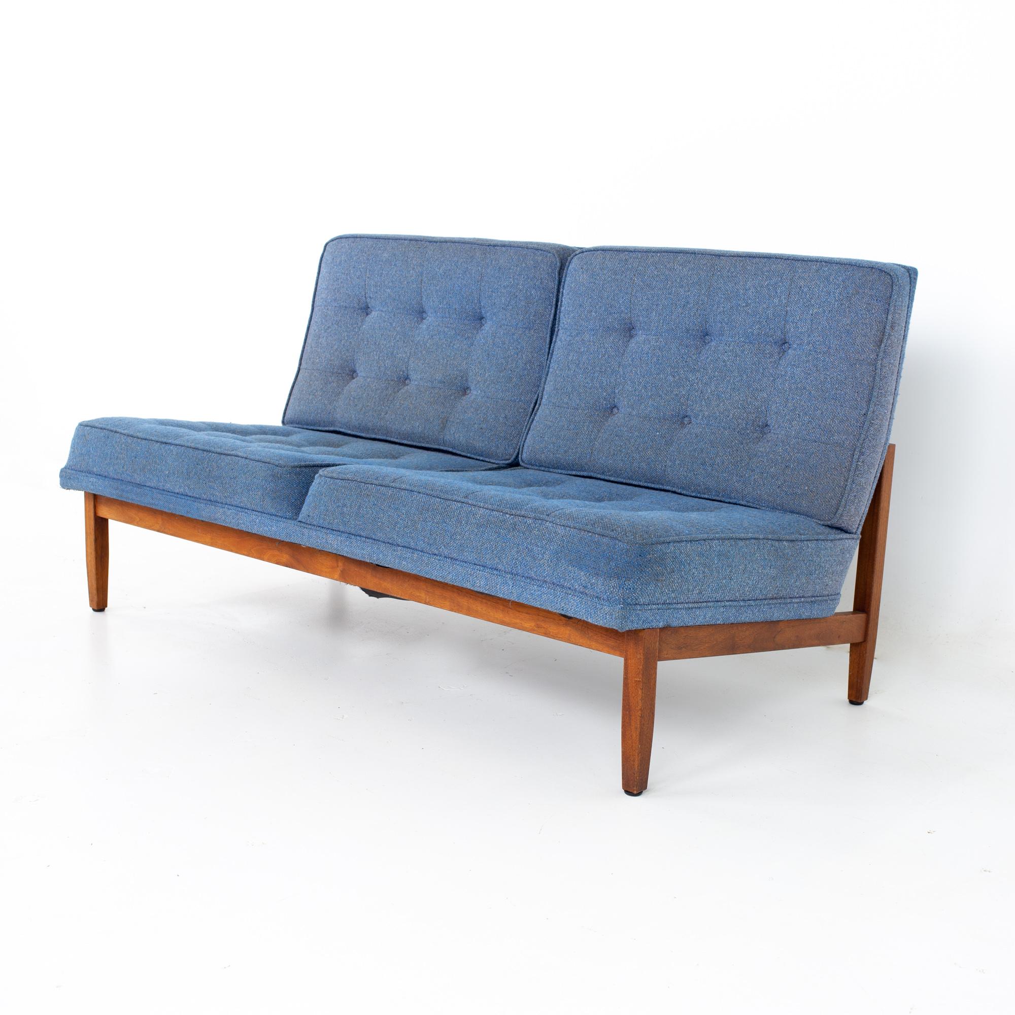 Early Florence knoll mid century parallel bar walnut blue settee love seat sofa.
Sofa measures: 56 wide x 29 deep x 29.75 high, with a seat height of 15 inches

All pieces of furniture can be had in what we call restored vintage condition. That
