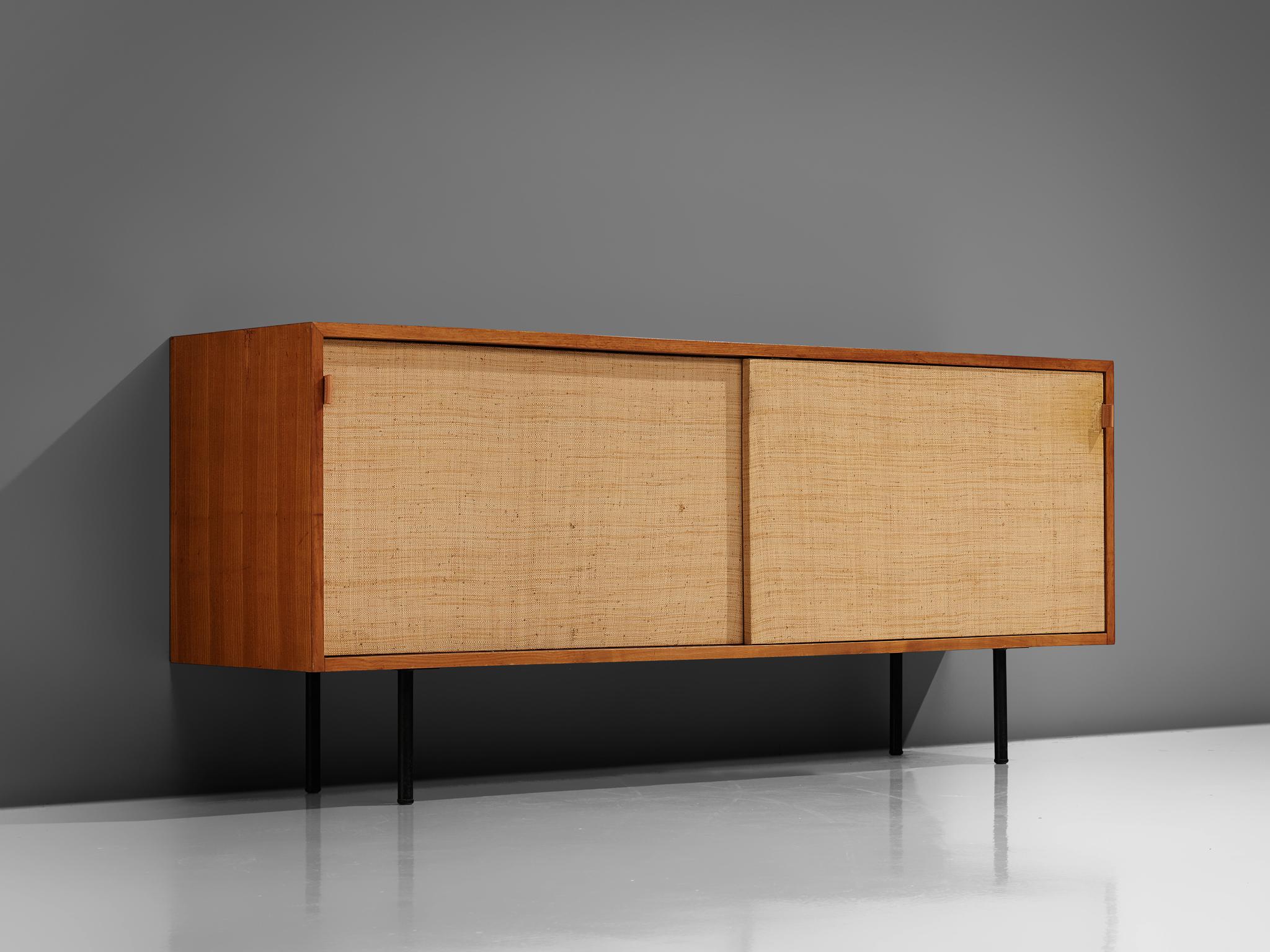 Florence Knoll for Knoll International, sideboard, walnut, seagrass, cane, steel and leather, United States, 1948.

An early office-residential crossover piece. The wooden sideboard has two sliding doors which are covered with cane. Inside there