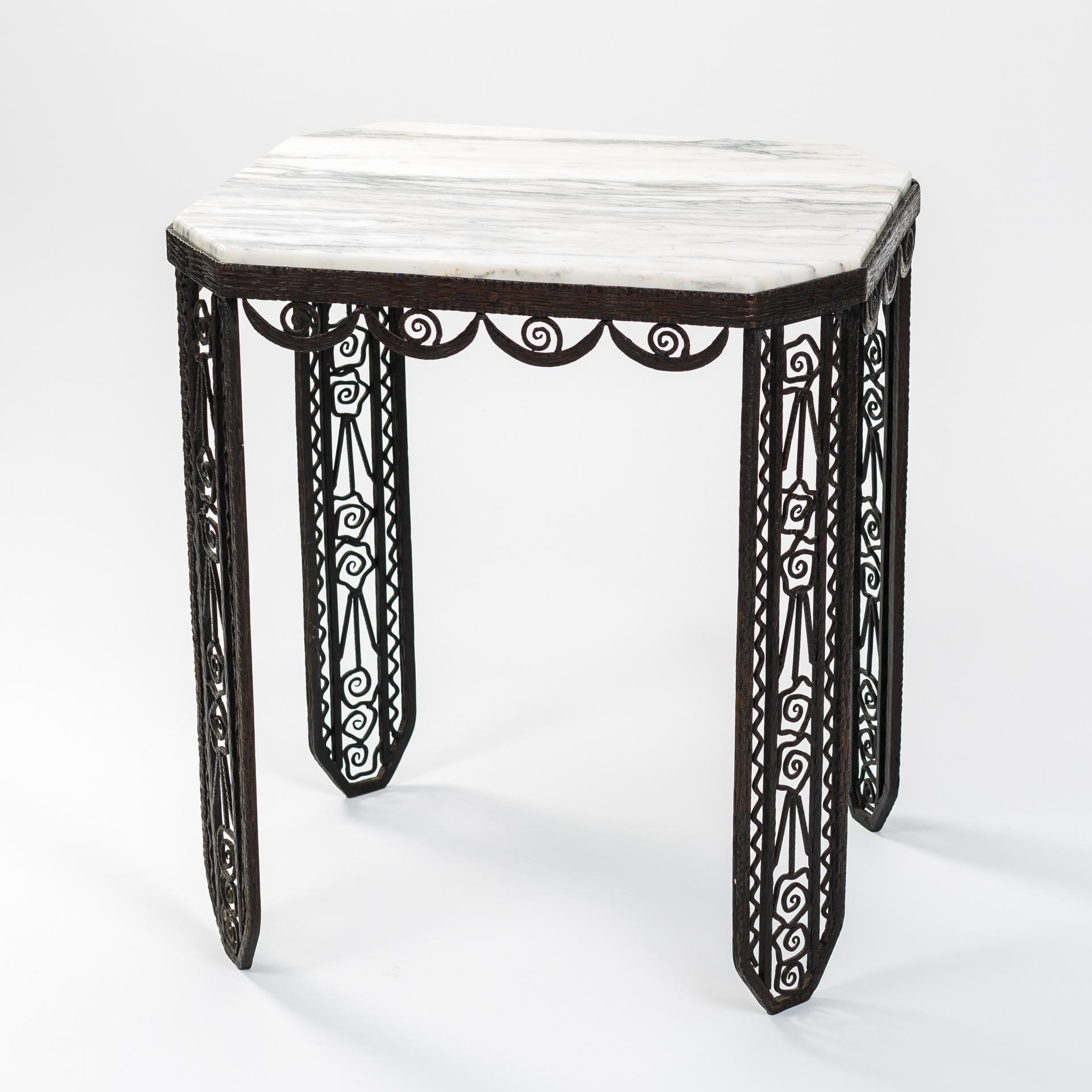 Extraordinary, elegant French Art Deco side table in a very fine, handcrafted version.
Stylized, floral elements adorn the iron frame.
Marble top in white, gray, beige colored grain.
Undamaged original condition.



           