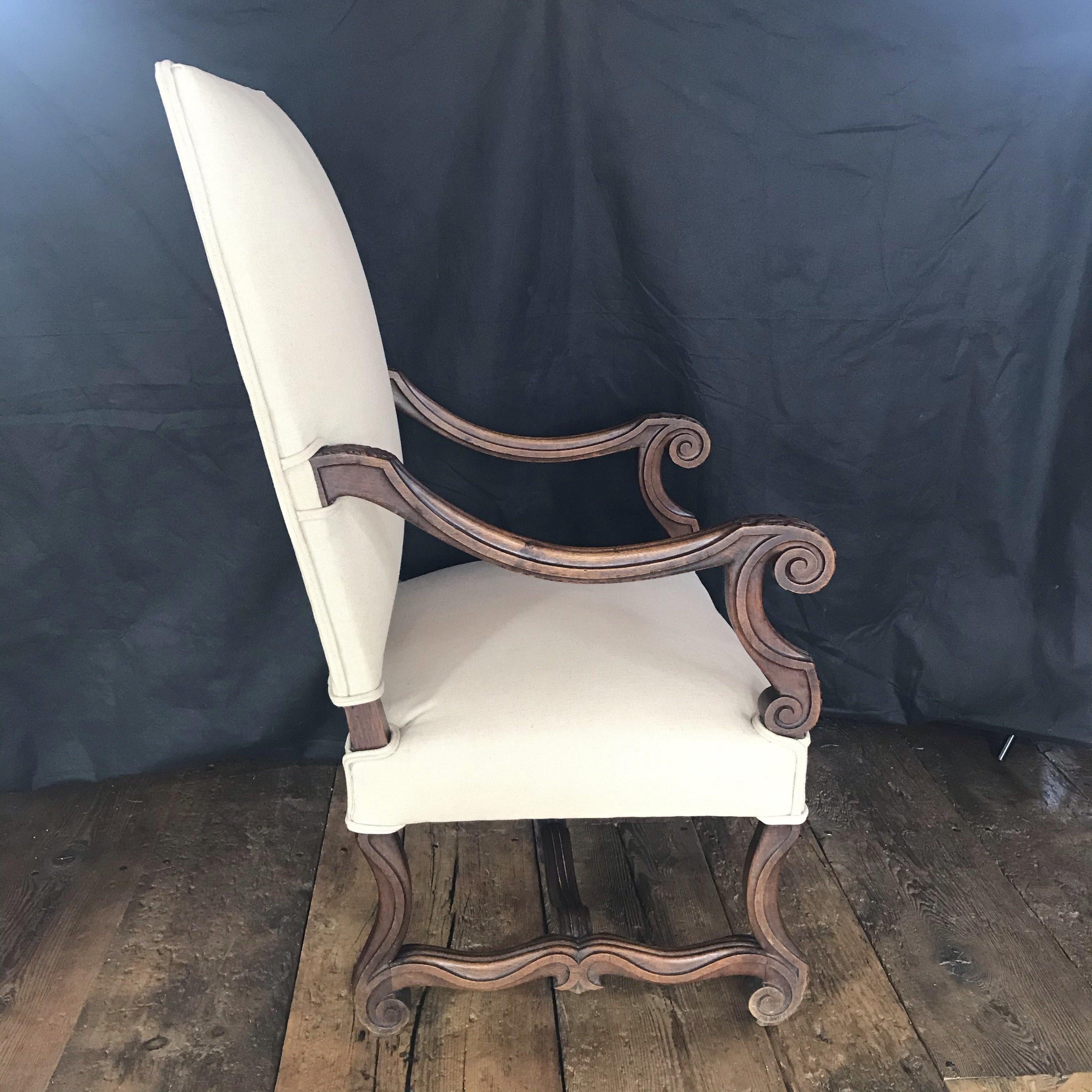 Gorgeous and comfortable French Louis XV carved armchair or fauteuil newly upholstered in neutral French linen. Carved reeded legs and arms add to the elegance of this chair, which can be used as a head dining chair or as a separate