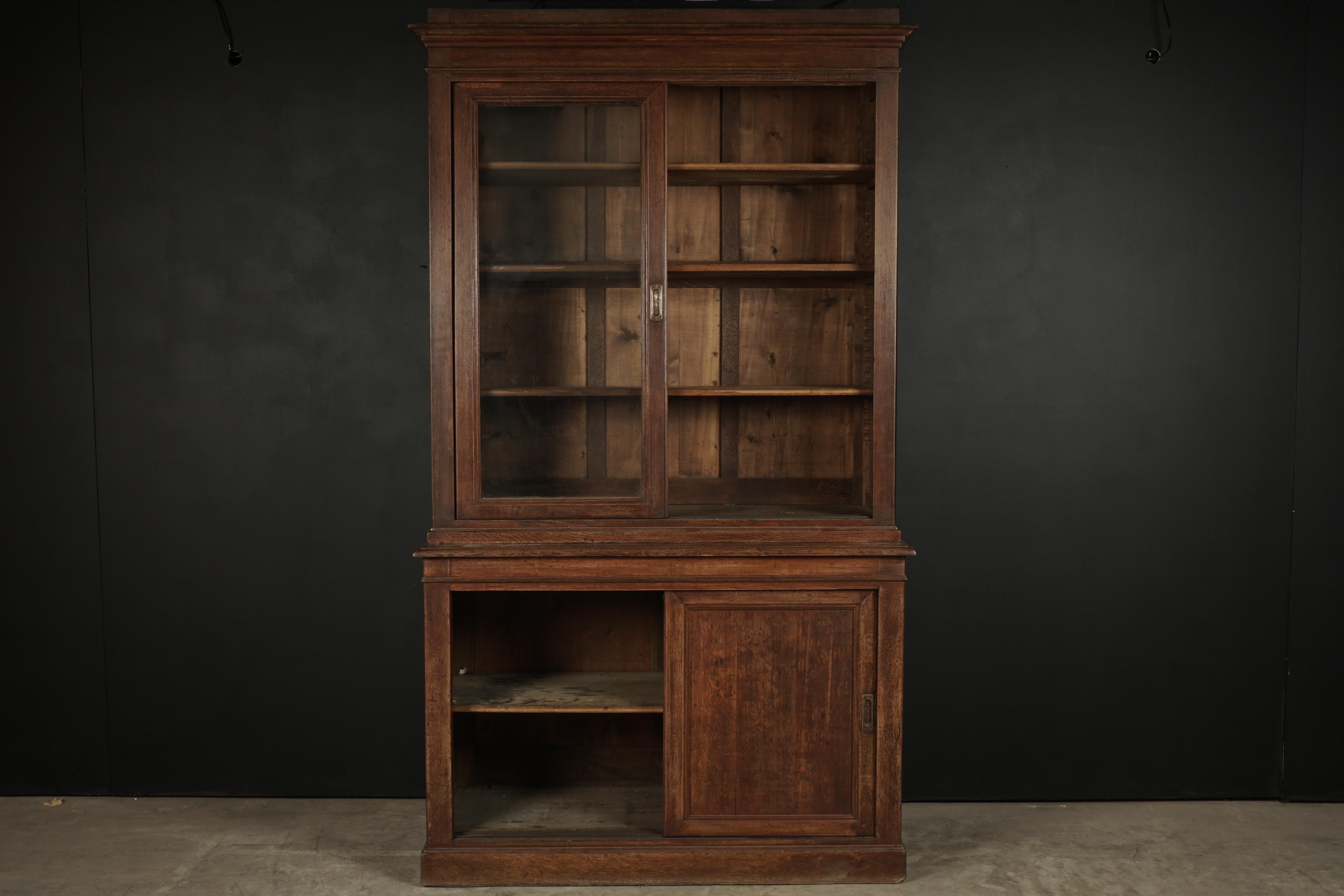 Early French oak cabinet with sliding doors, circa 1920. Two-piece cabinet with fantastic patina and function.

                         