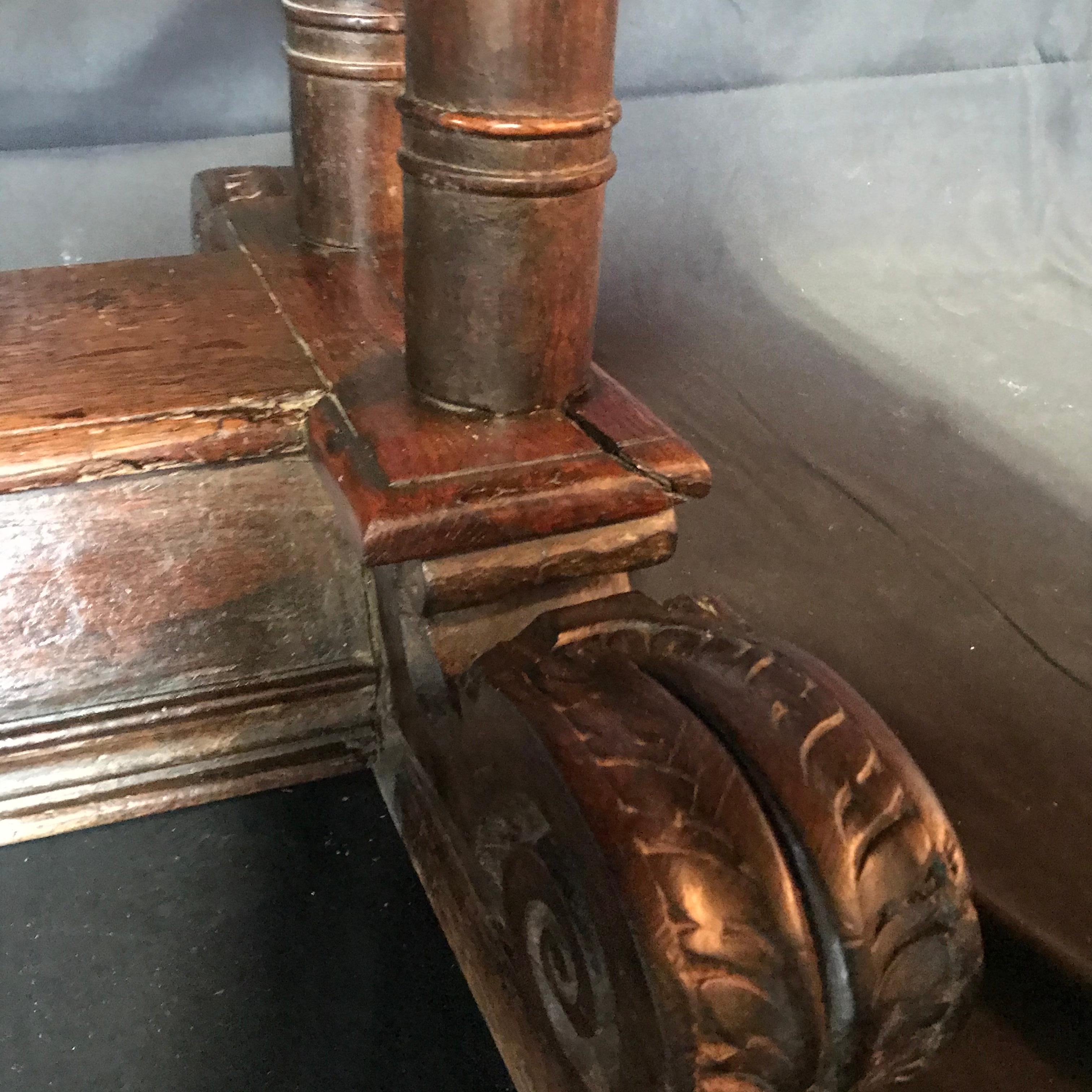 Super early oak French refectory table with two inset leaves. Early columned base with scrollwork carved feet. Opens to a huge 118.25