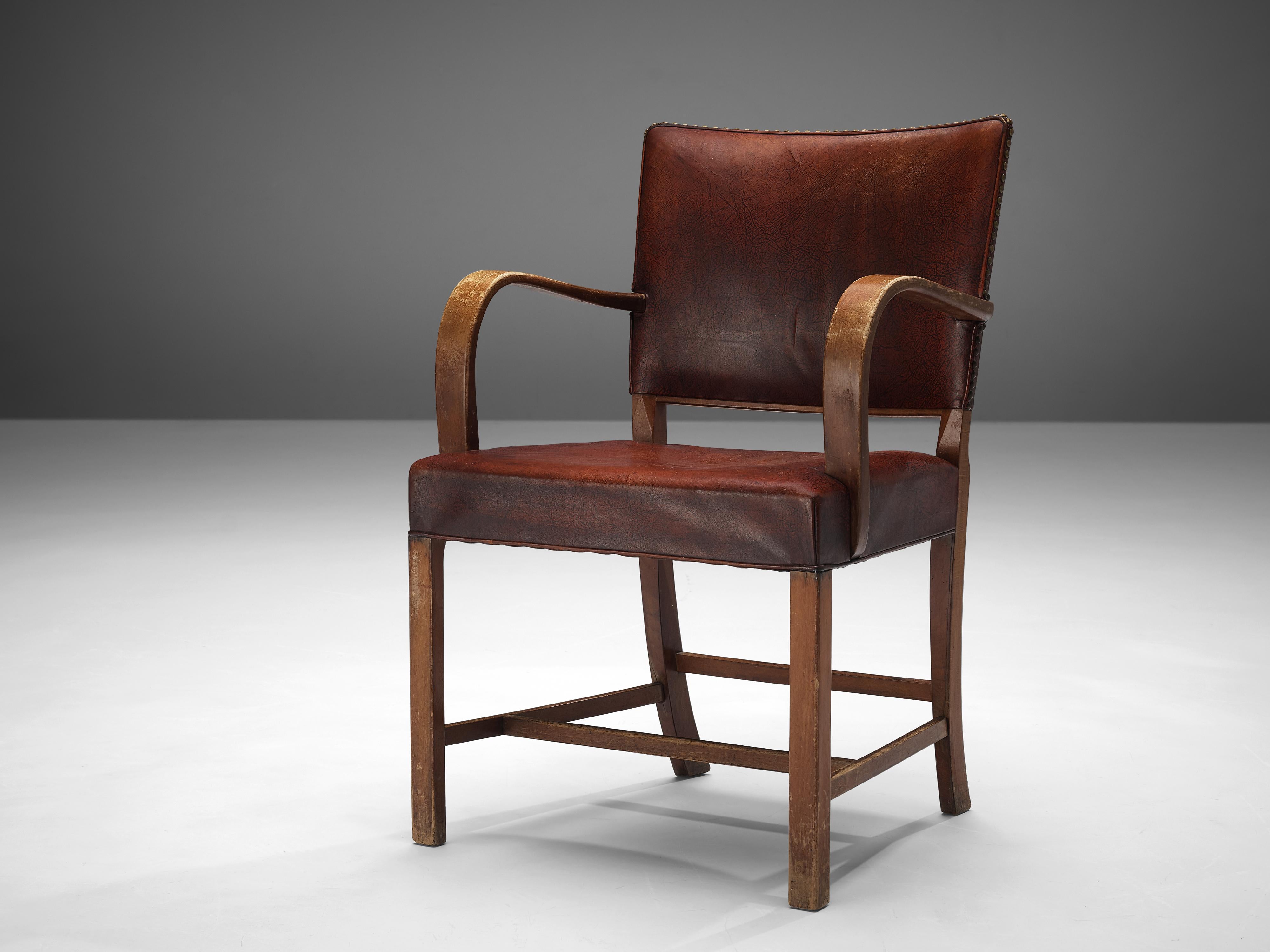 Fritz Hansen, armchair model '1561', wood, patinated leather, brass, Denmark, designed in 1942

The appearance of this early Fritz Hansen armchair from 1942 is breathtaking. The way the patinated red leather is attached to the frame with brass