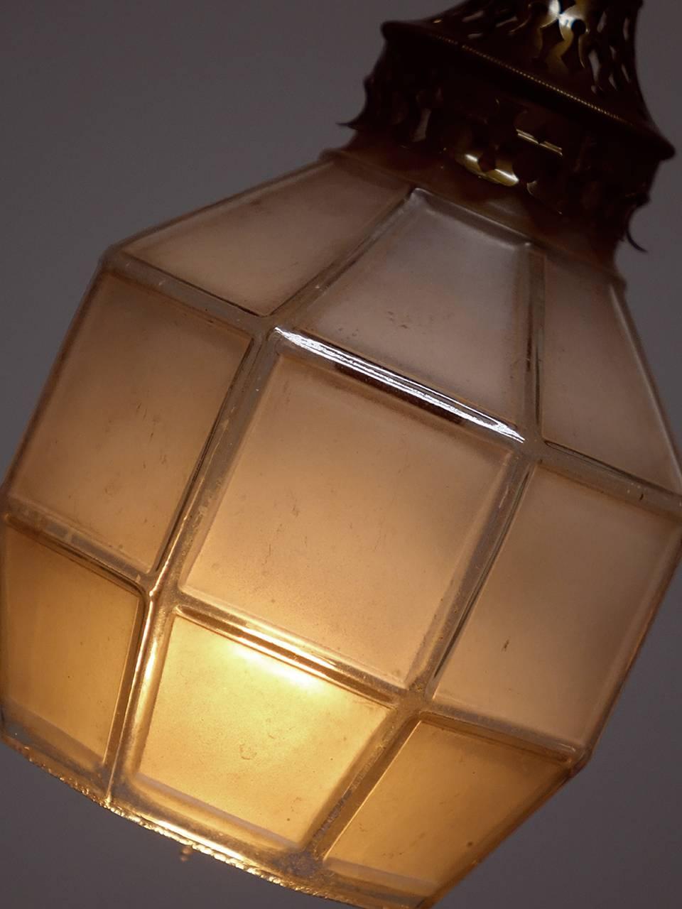 These delicate and early Arts & Crafts style shades were originally used for gas lamps. We rewired each using the original brass fittings to take a candelabra bulb. The glass is cast in one piece but looks like leaded glass panels. We have priced
