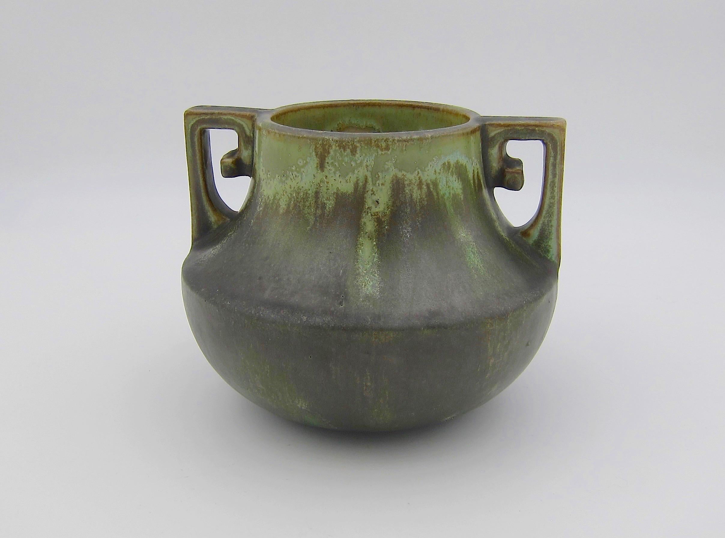 An early 20th century Arts & Crafts vase from Fulper Pottery of Flemington, New Jersey, dating circa 1910s. This American art pottery vessel is Fulper's 452 form with scrolled handles, decorated with a gorgeous matte Leopardskin glaze in shades of