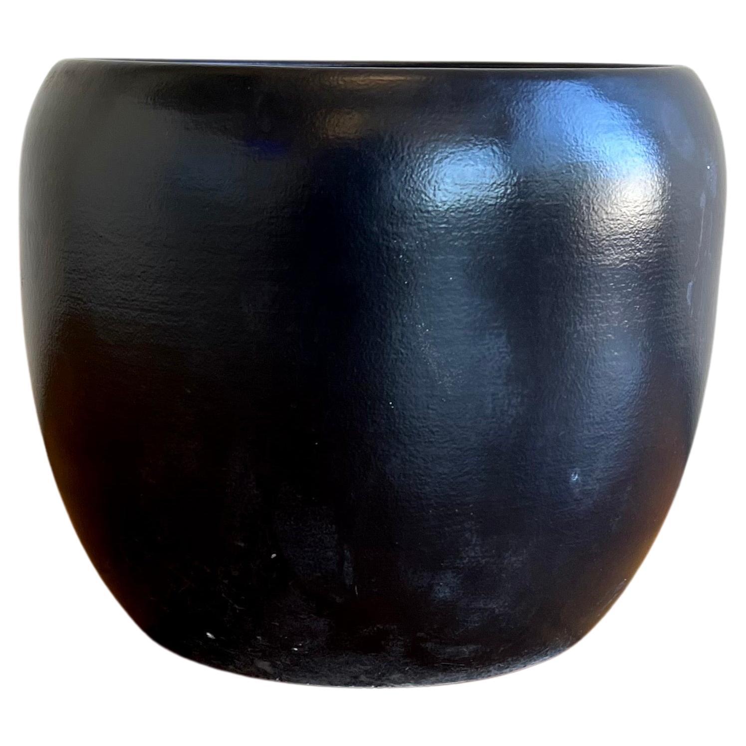 Large rounded planter pot. Earlier production by Gainey of LaVerne Ca. beautiful black glaze satin finish small chip repair on the bottom as shown invisible to the eye.