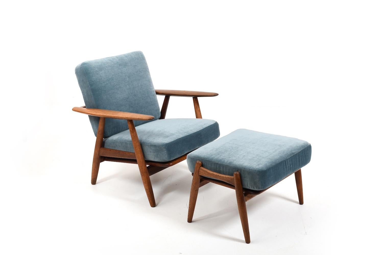 Early GE-240 (cigar chair & foot stool) by Hans J. Wegner for Getama, Denmark 1950s. Made in solid oak. Original cushions with new upholstery. In consideration of their age, the old feathers in the cushions were restored and reupholstered with a