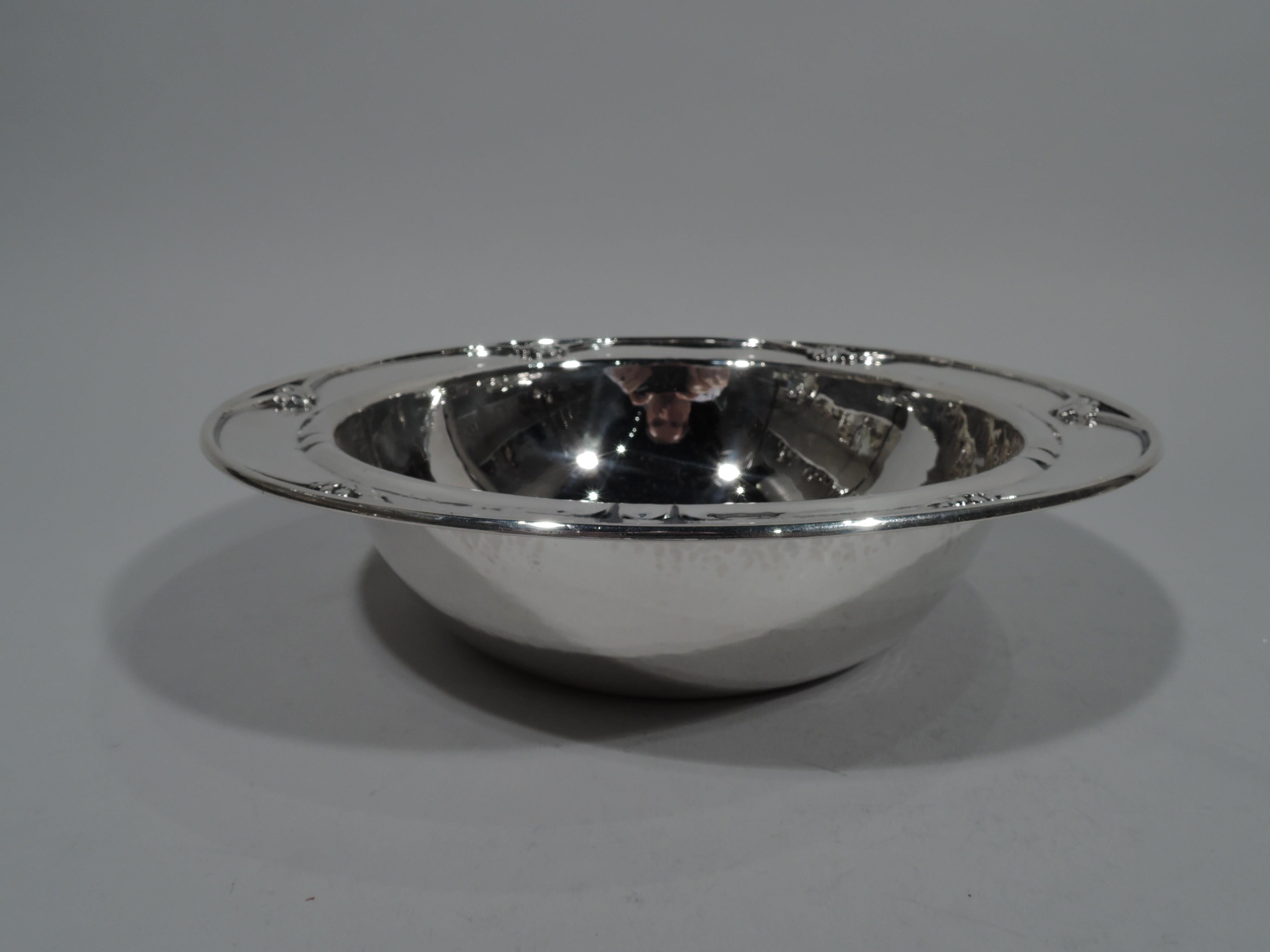 Art Deco sterling silver bowl. Made by Georg Jensen in Copenhagen. Round with curved sides and flat rim. Applied berry bunches and incised notches. Visible hand hammering with nice shimmer. Fully marked with 2 early maker’s stamps from 1915-30 and