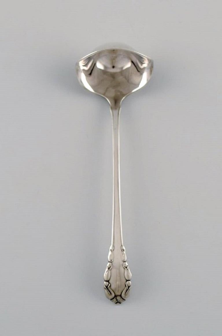 Early Georg Jensen Lily of the Valley sauce spoon in sterling silver. 
Dated 1915-1930.
Length: 13 cm.
In excellent condition.
Stamped.
Our skilled Georg Jensen silversmith / goldsmith can polish all silver and gold so that it appears new. The