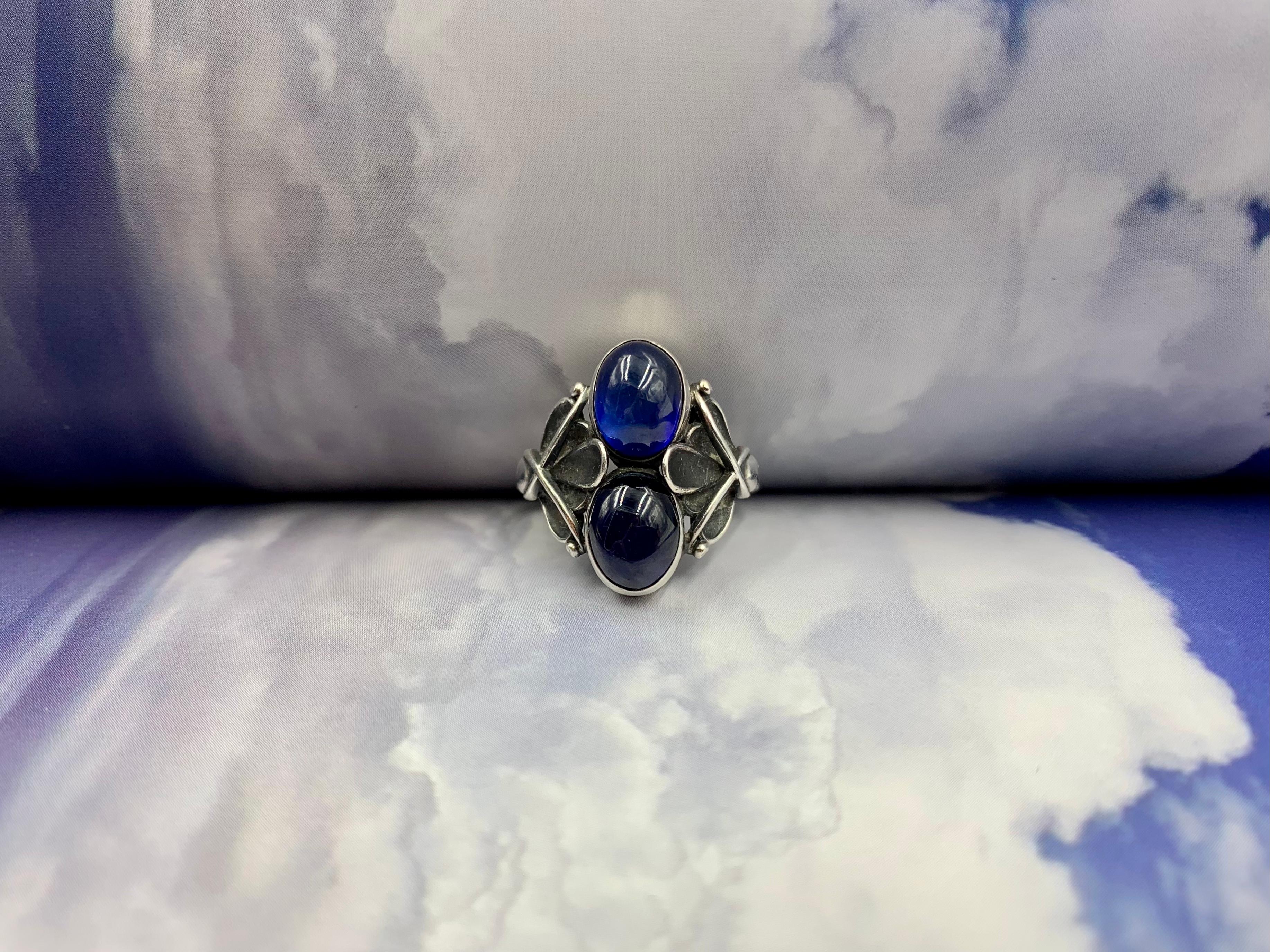 Early estate Georg Jensen Moonlight Blossom cabochon sapphire and sterling silver ring.
1933-1944
Designed by Henry Pilstrup for Georg Jensen
Provenance: from the estate of a notable New York City psychiatrist and collector of rare, unusual