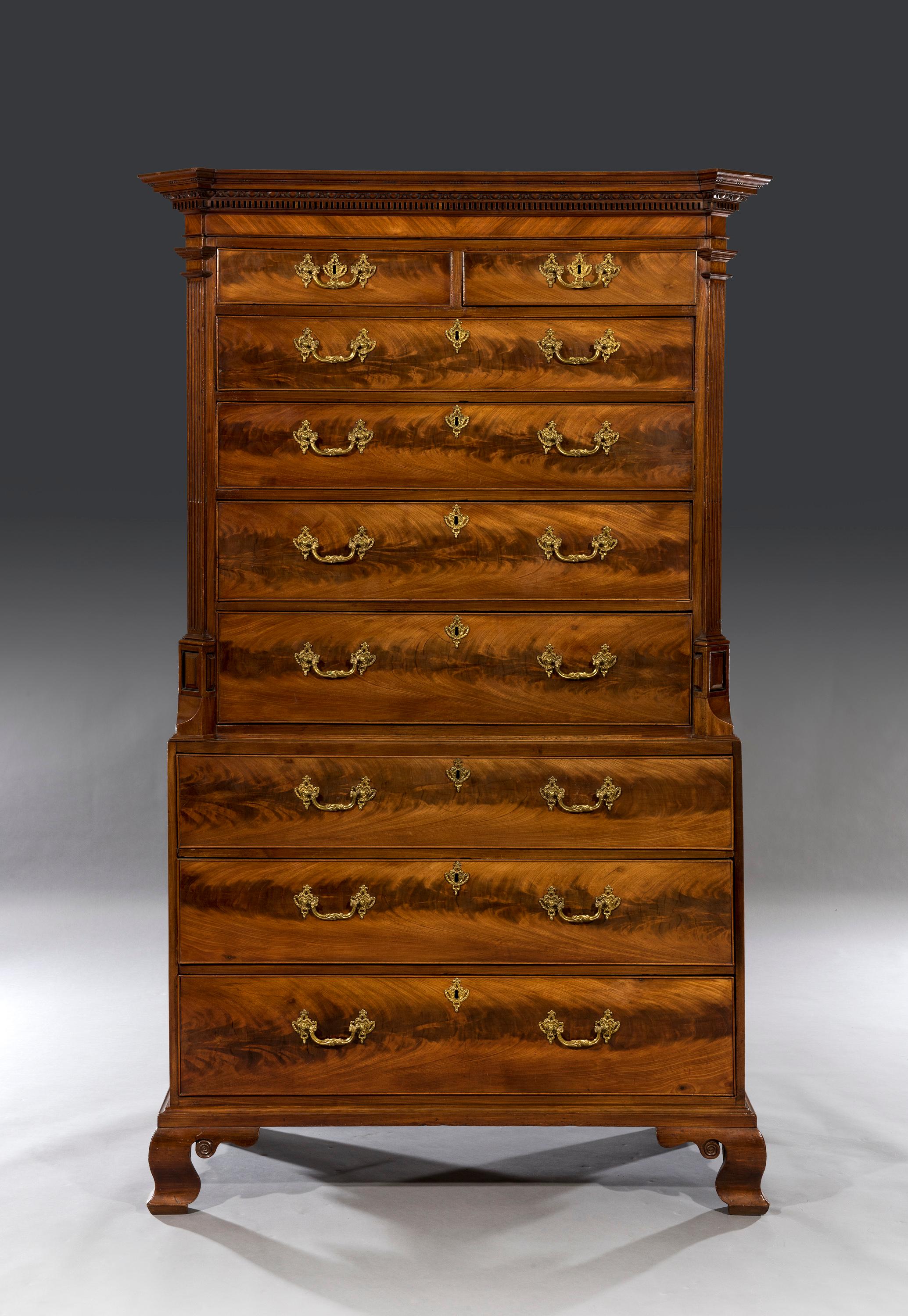 The top section is decorated with an 'egg & dart' moulding and a dental cornice with out-set corners above two short and four long graduated drawers flanked by fluted canted corners. The full length oak lined drawers retain the original locks and