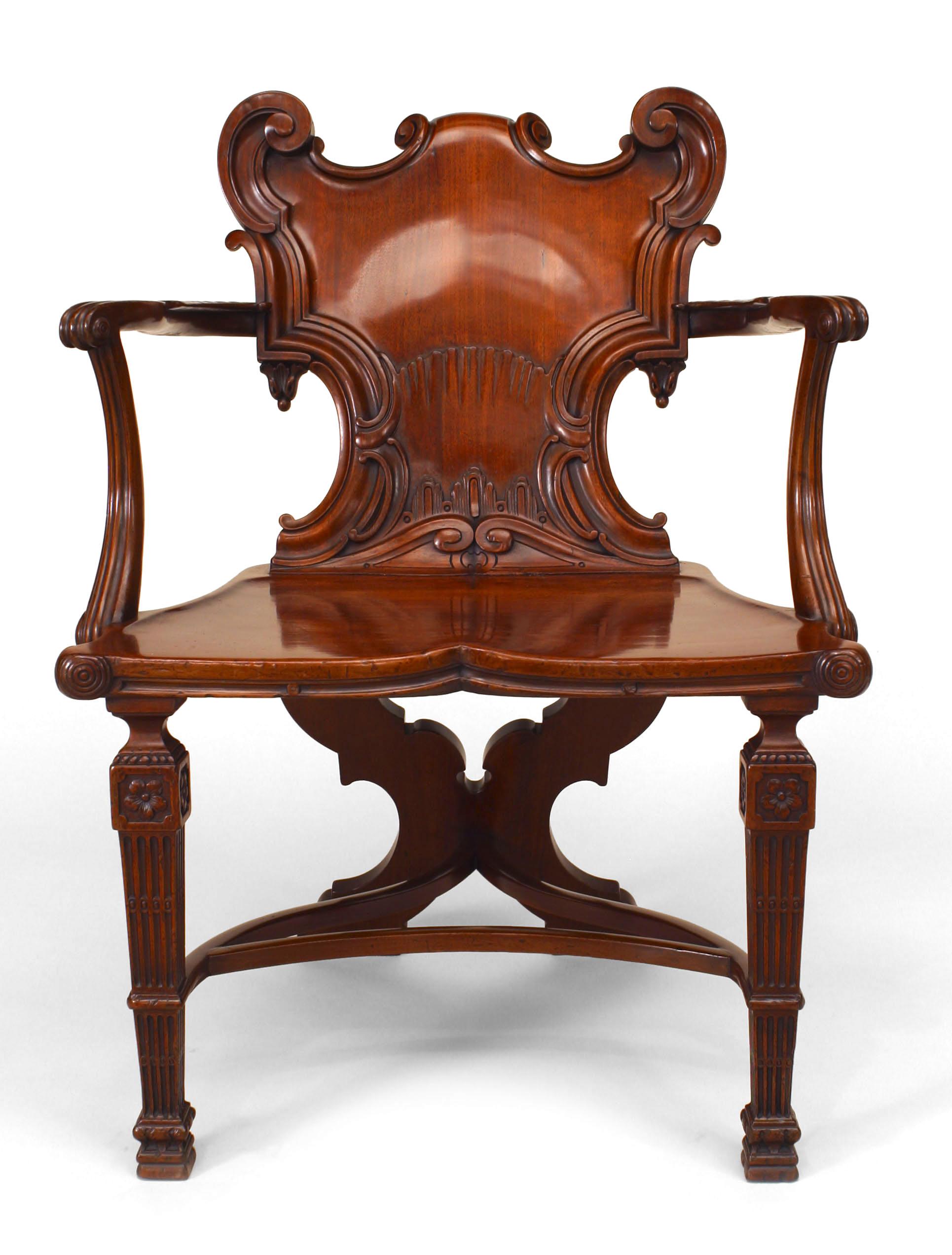 English Georgian (1765) mahogany arm chair with carved shield form back supported on 2 fluted square tapered front legs connected with a 3 point curved stretcher to an 