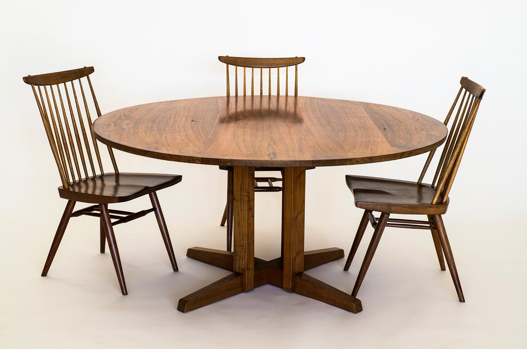 A stunning and large early George Nakashima cluster table in walnut.