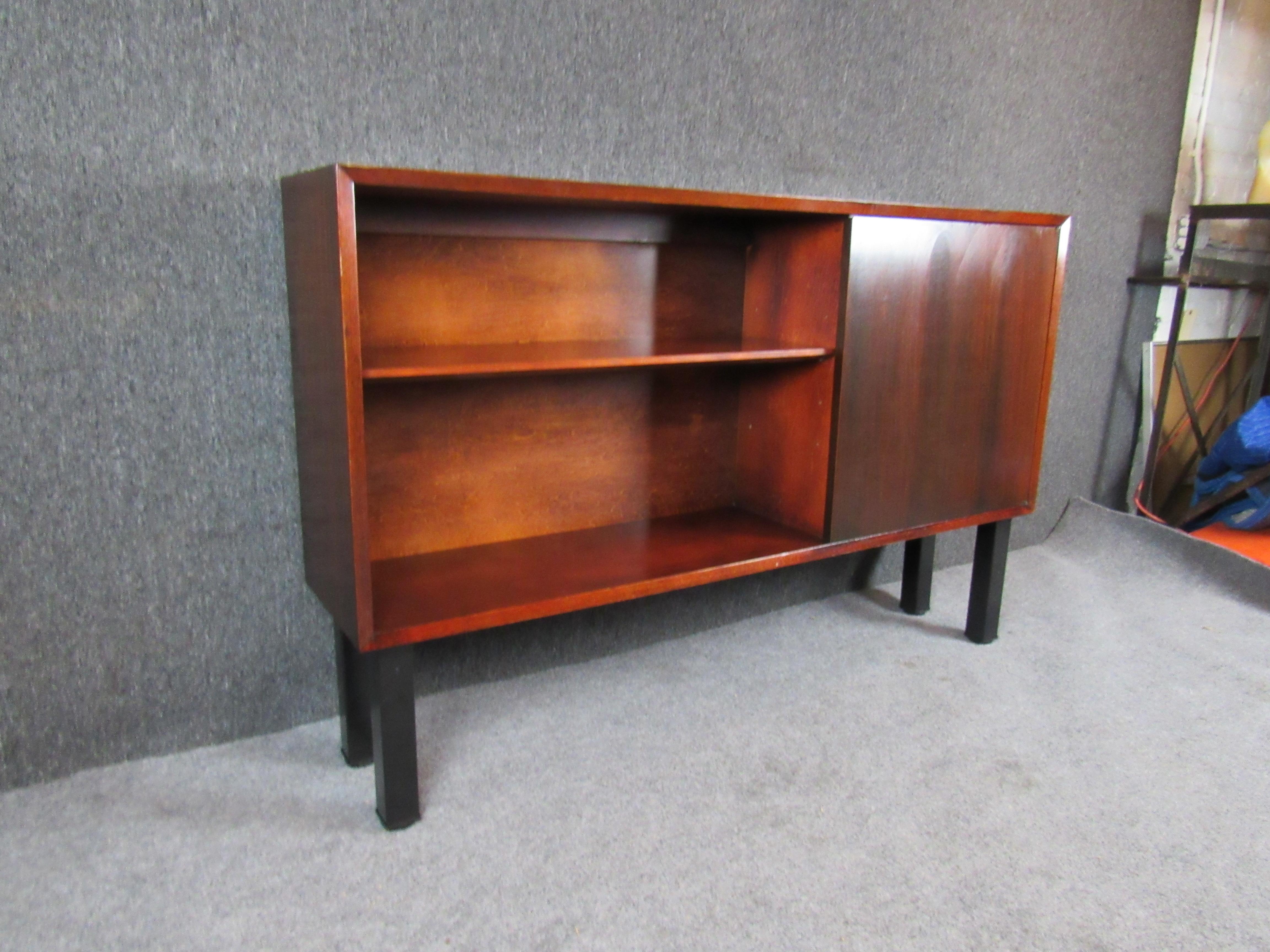 Very unique vintage cabinet designed by George Nelson and manufactured by Herman Miller at their Zeeland, Michigan factory. This early example features an unusual mahogany construction and still bears its original foil stamp, dating it to the early