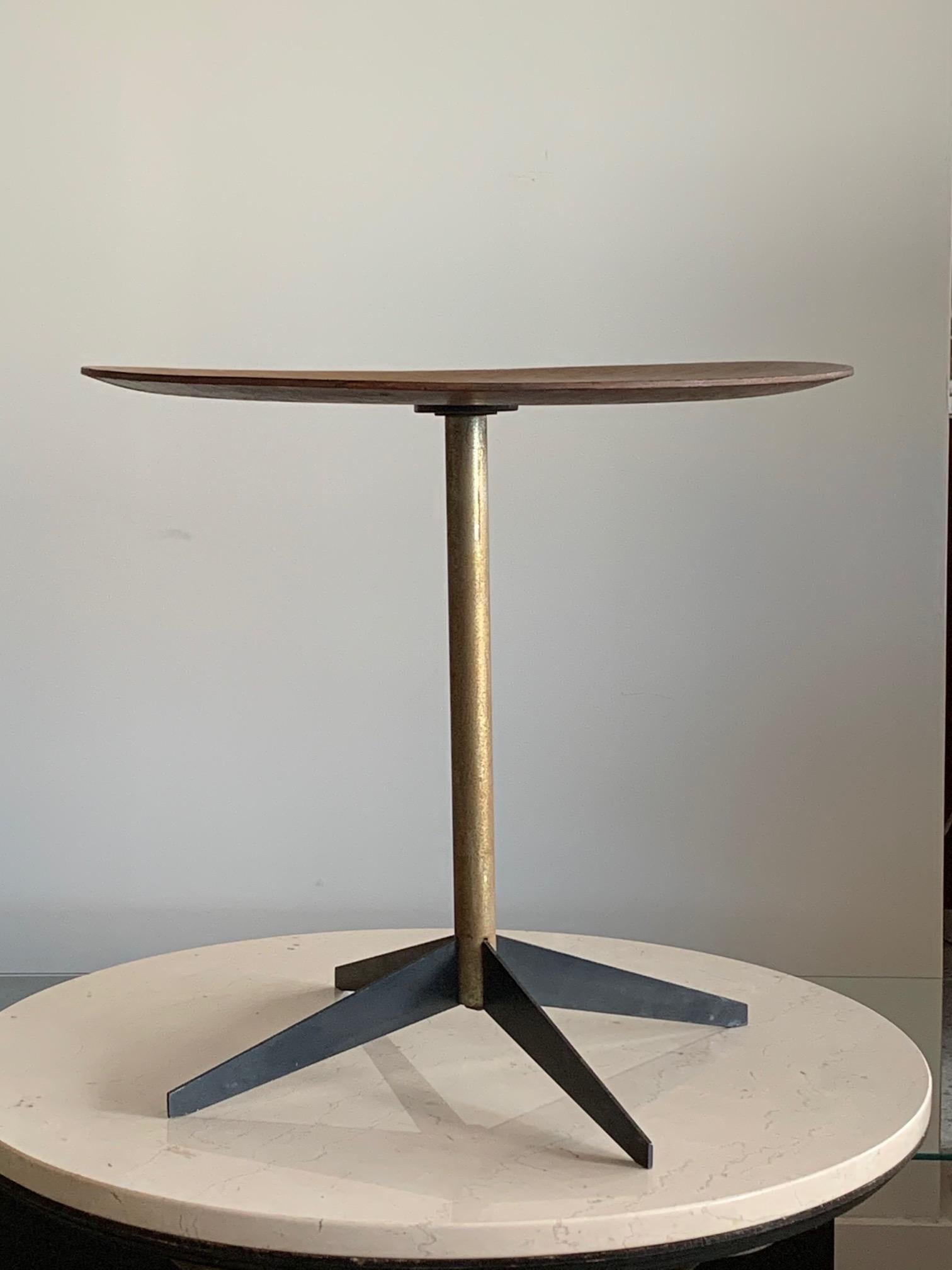 An early side table by George Nelson for Herman Miller with a steel four prong base. From the estate of Irving Harper. This table has patina and character.