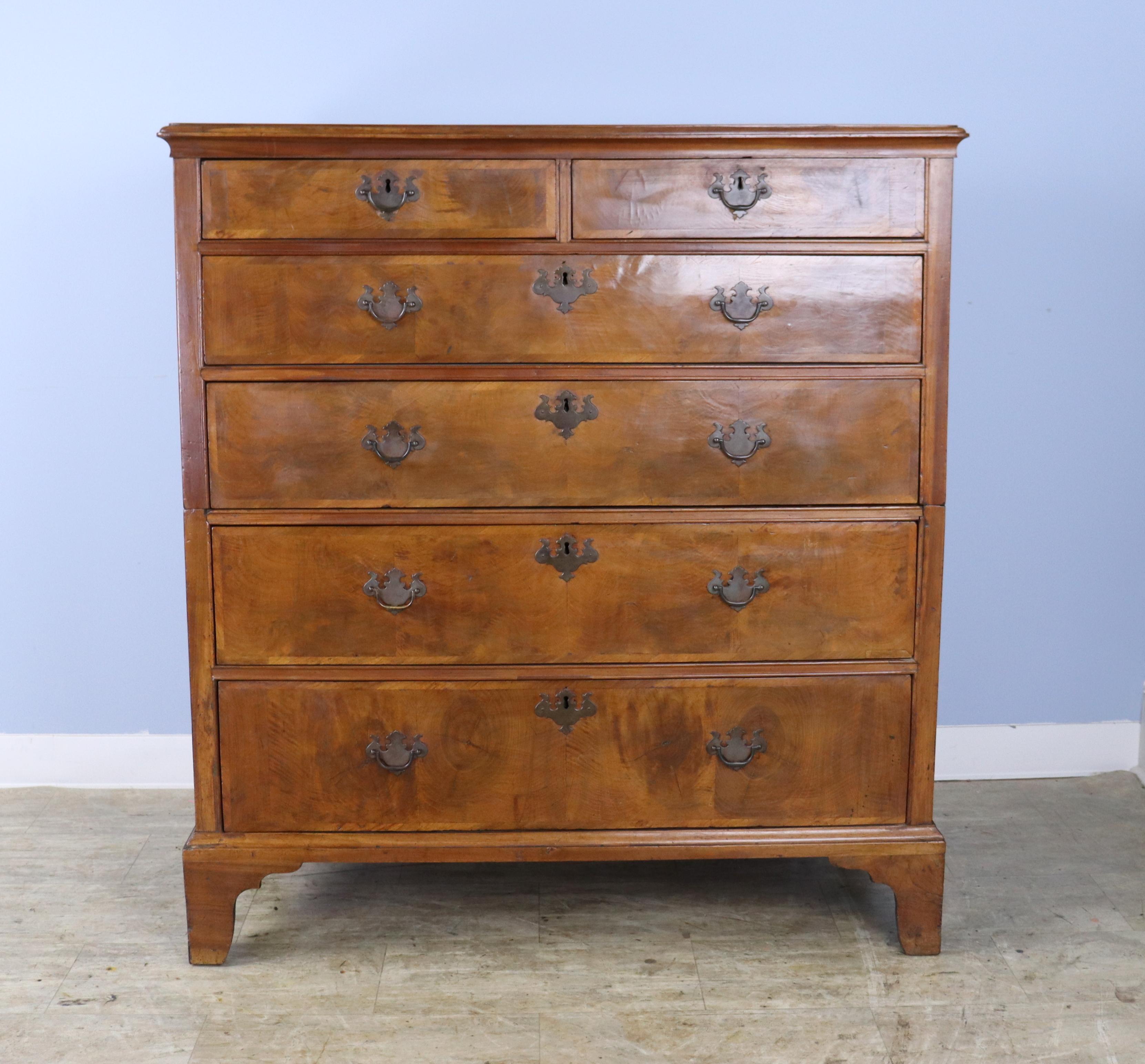 This George I dresser is in very good condition for it's age.  The bookmatched walnut veneer is lovely, with good patina and warm walnut color.  Original ogee feet and brasses.  Classic 2 over 4 construction.  