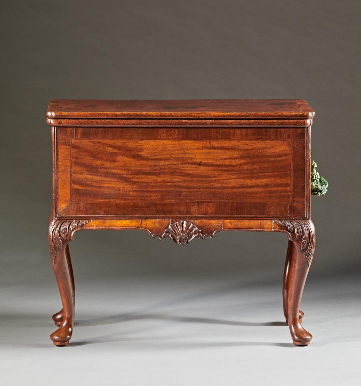 A very fine George II mahogany counting table, the rectangular folding top opening to a ratcheted writing/drawing tablet with crossbanded edging on a conforming case with applied bulged apron. The case is fitted with working drawers and is finished