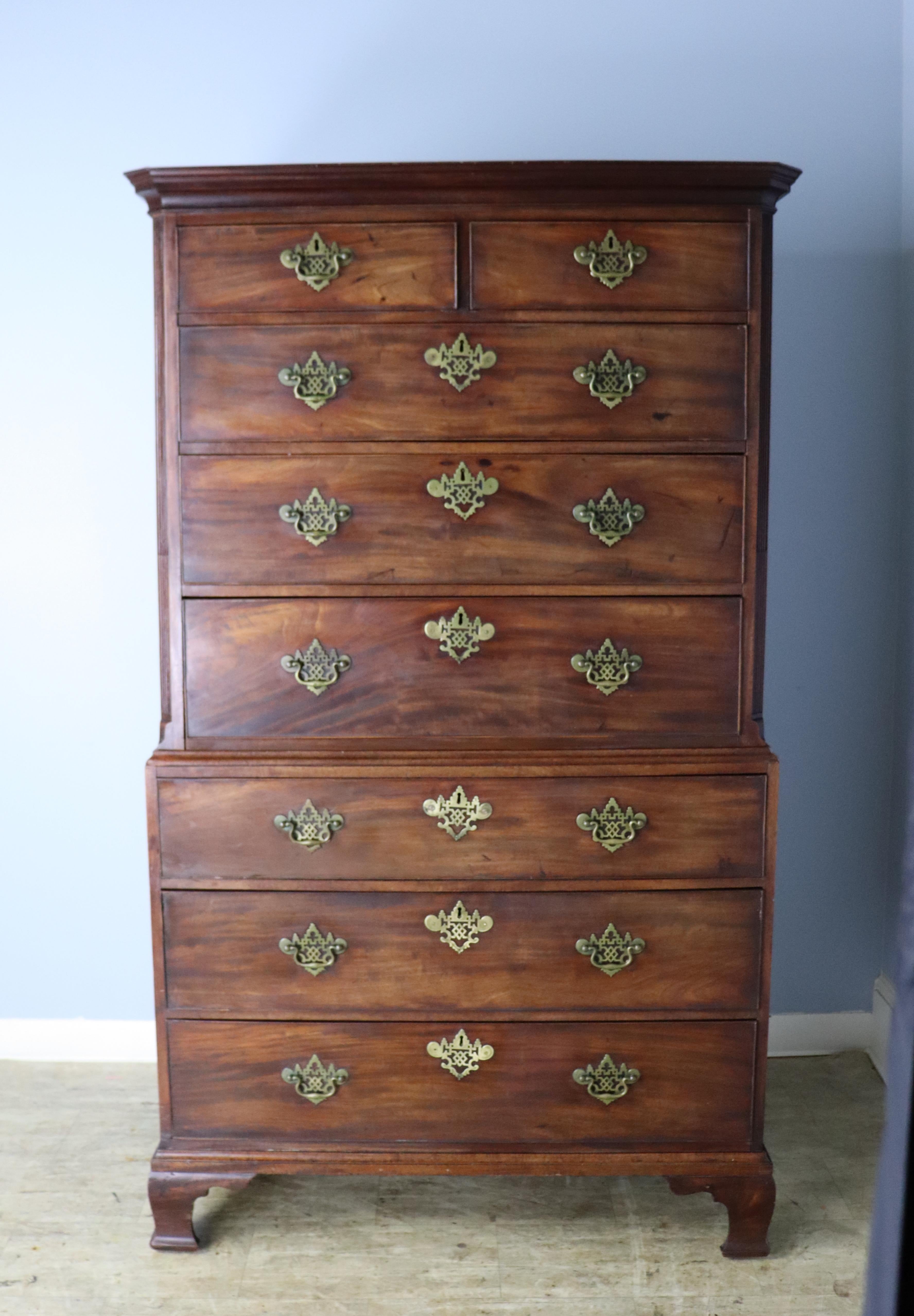 An early Georgian chest on chest of imposing size and beauty.  The mahogany has lovely patina and mellow grain.  Original brasses are in good uniform antique condition.  Reeded corners on the body of the piece and cockbeaded drawers add further