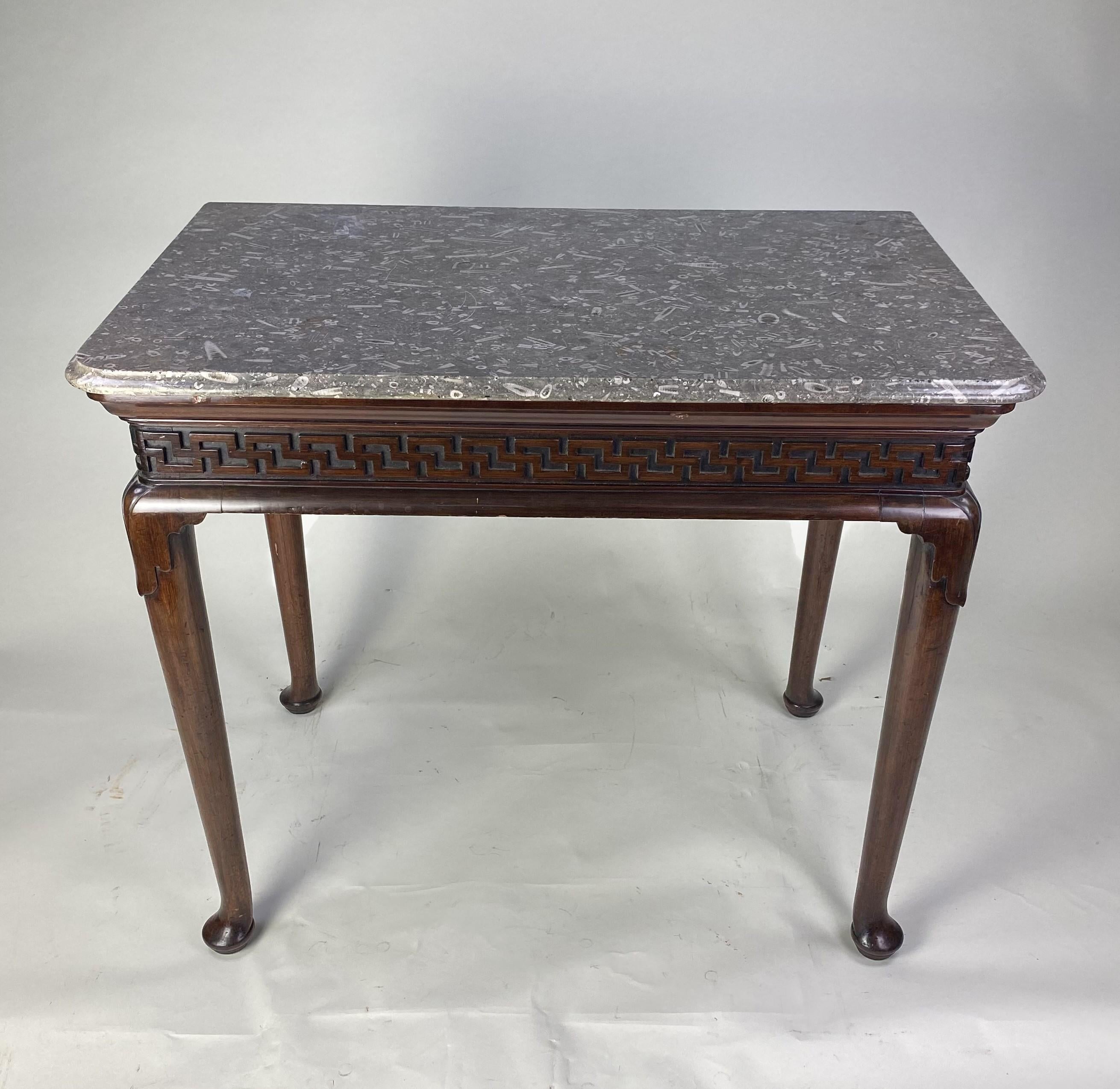 A fine and rare early 18th century red walnut cabriole leg Hall Table with rare and original mable top, known as 'Derbyshire Fossil'. The apron decorated with an usual geometric pattern similar to a 'Greek Key' ornament. this unusual pattern has
