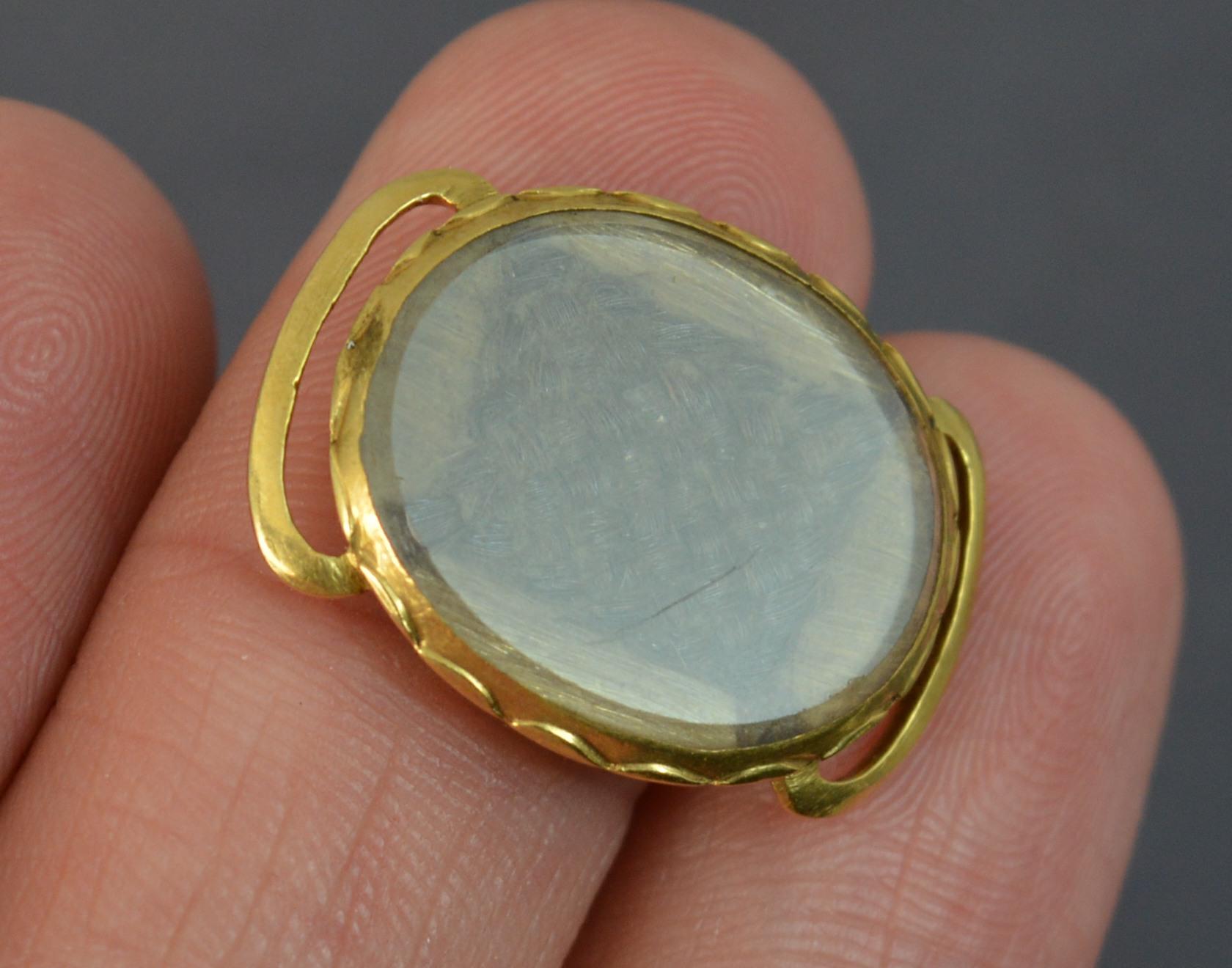 A stunning true early Georgian era Stuart Crystal mourning slider.
Original order in 18 carat yellow gold. Slider bars and plain reverse. The front houses a braided hair section.

The mystique of the crystals is embedded in the history of the jewels