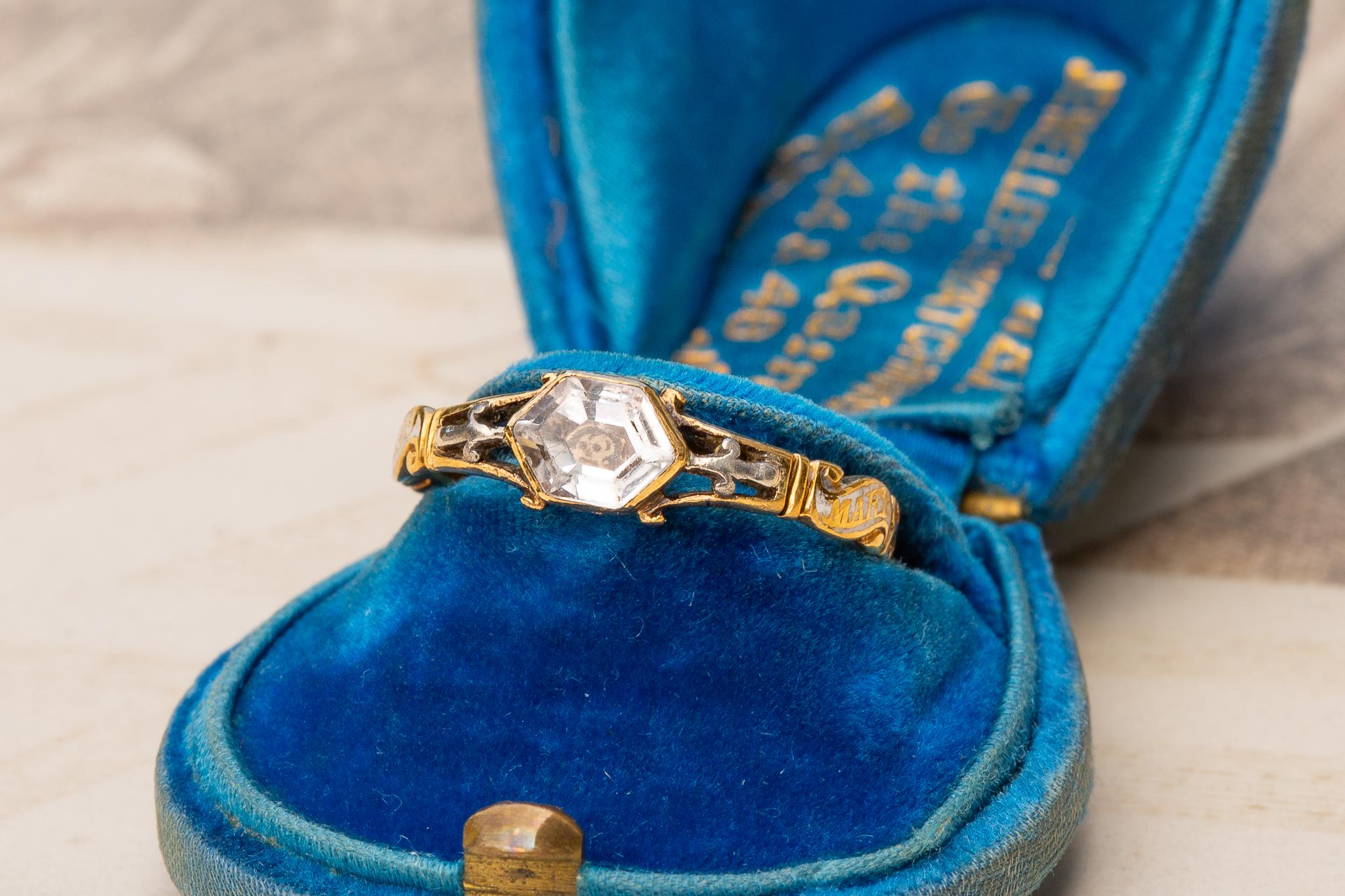 An exquisite mid-18th century Georgian period mourning ring. The hexagonal crystal is inlaid with a memento mori skull and crossbones motif. This ring is steeped with history and is a remarkable example of early Georgian period Stuart crystal