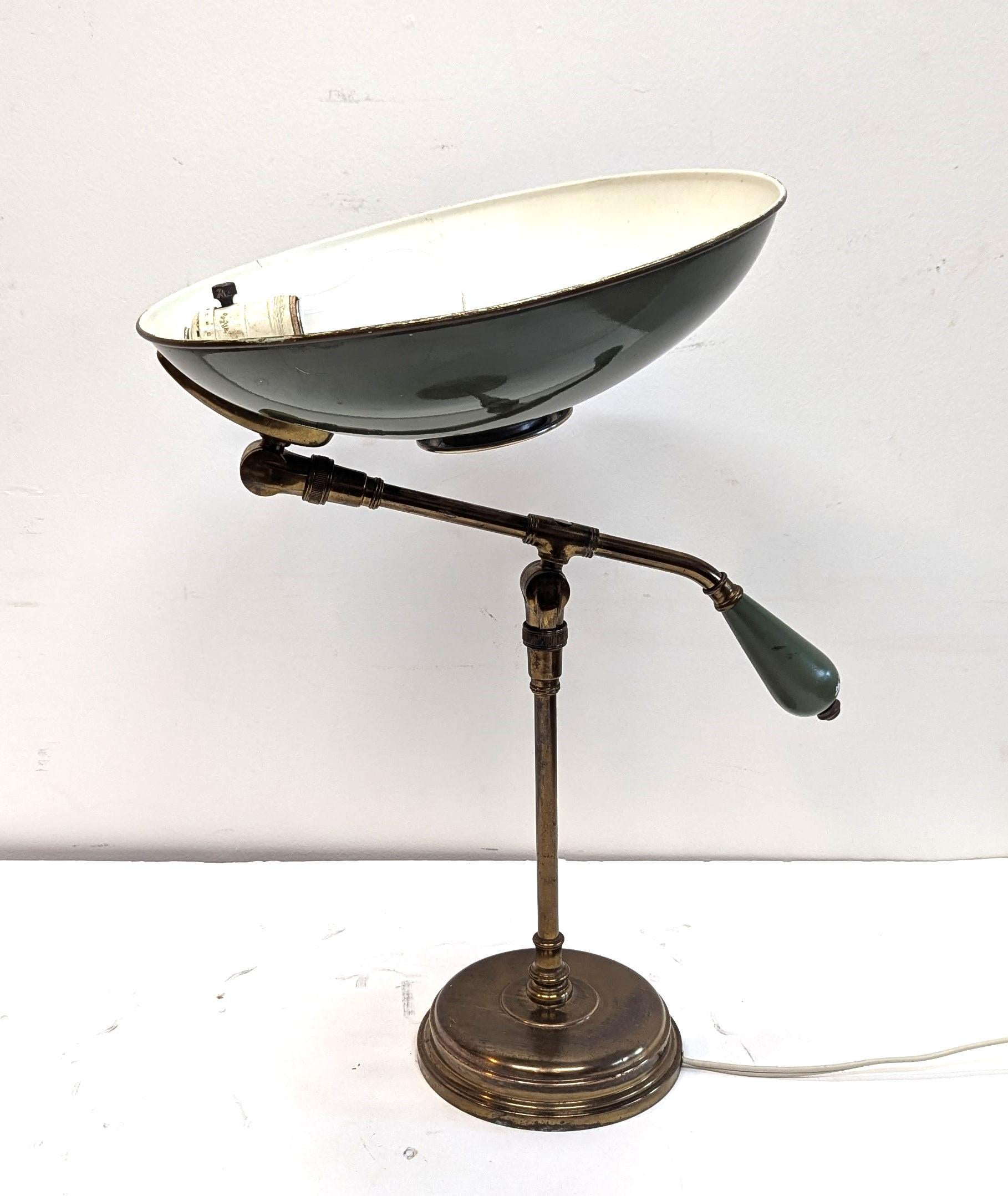 Early Gerald Thurston Articulating Desk Lamp.  Great desk lamp arm moves up down and turns side to side.  Shade also pivots 90% up and down and can be turned side to side.  All original, olive green paint and brass patina.   Brass and bronze can be