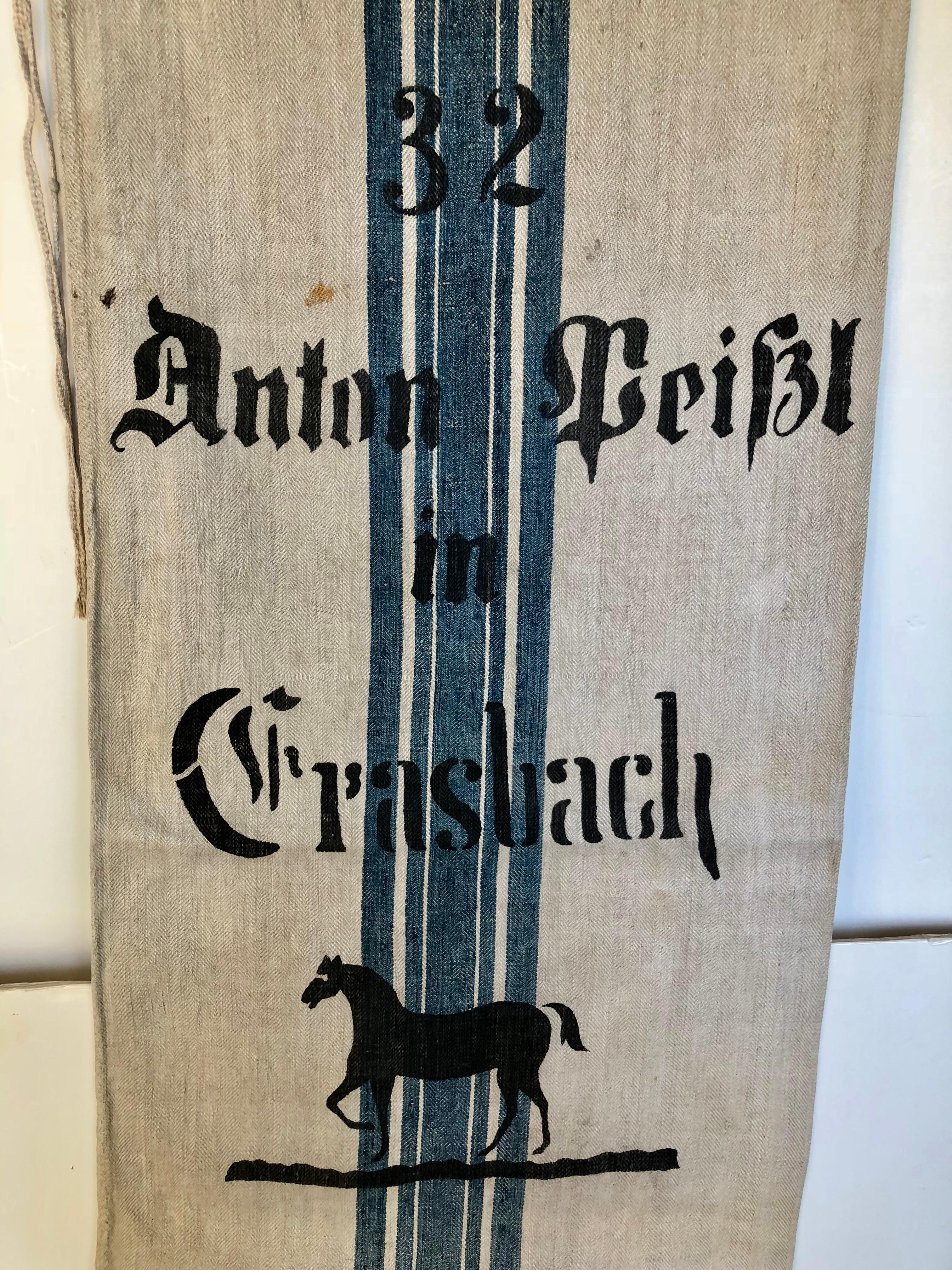 Early German handwoven grain sack with original graphics and calligraphy. It was made from linen and hemp by the farmer's wife and used to store grains in the barn. The farmer's name, town and inventory # were starting, ped with black tar. It was