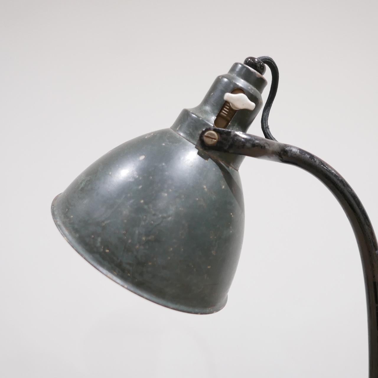 An antique German table lamp by Kandem. 

Early 20th century, Bauhaus.

Original and correct dark green paint to the shade. 

Re-wired with black silk flex. 

The kind of table lamp that has lasted 100 years and will go on for another 100.
