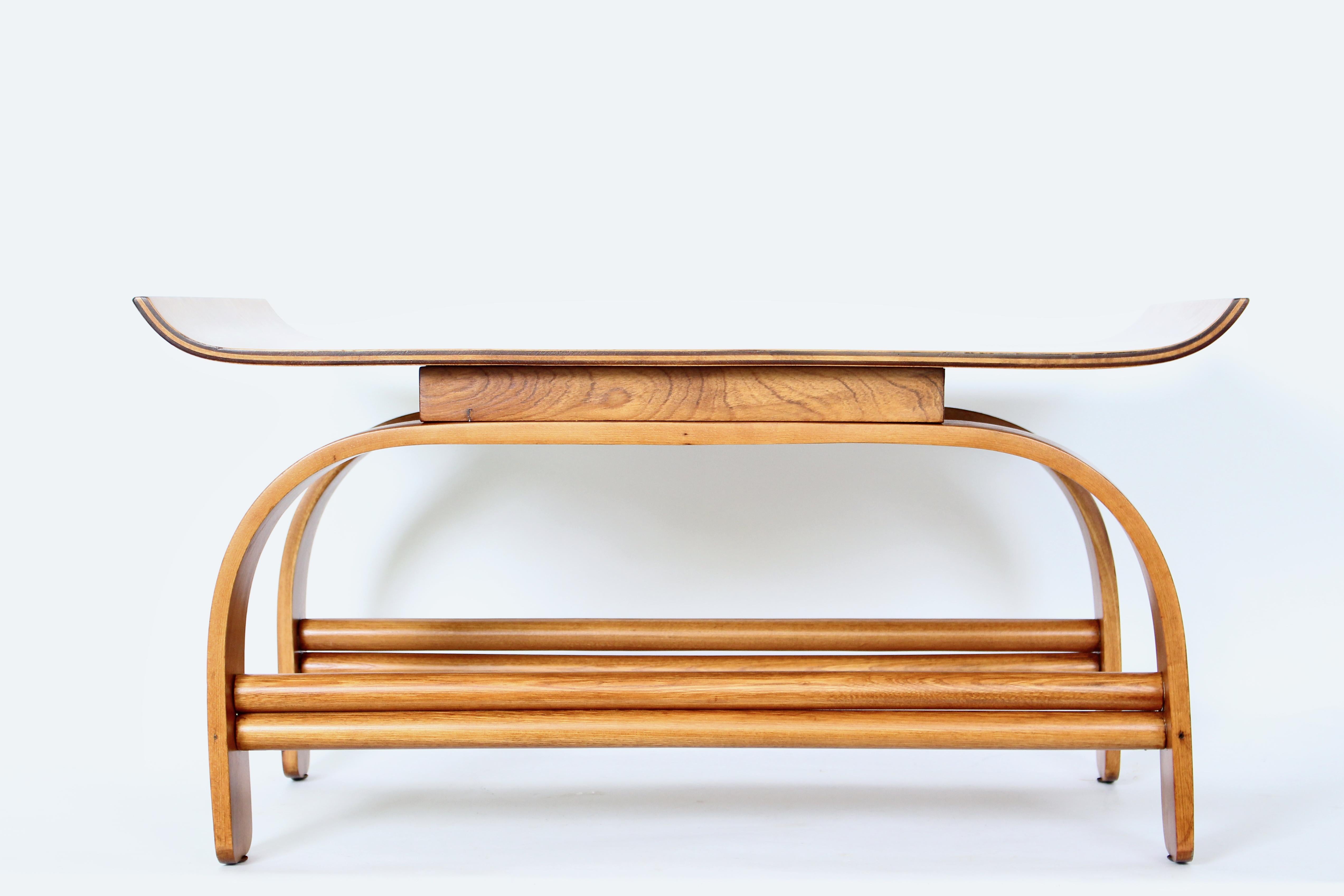 Gilbert Rohde for Heywood Wakefield Steam Bent Maple Coffee Table, C. 1930.  Featuring a floating, laminated steam bent Maple surface, flared upturned ends,  rectangular Maple lift, double tier dowels, a top balanced double doweled reinforced steam