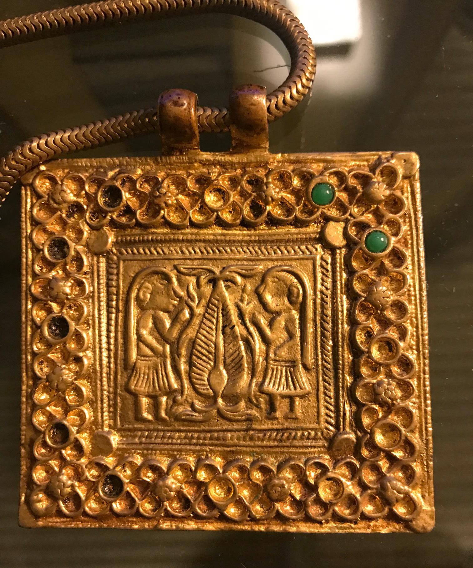 A gilt bronze necklace with chain and a square plaque on the subject of 