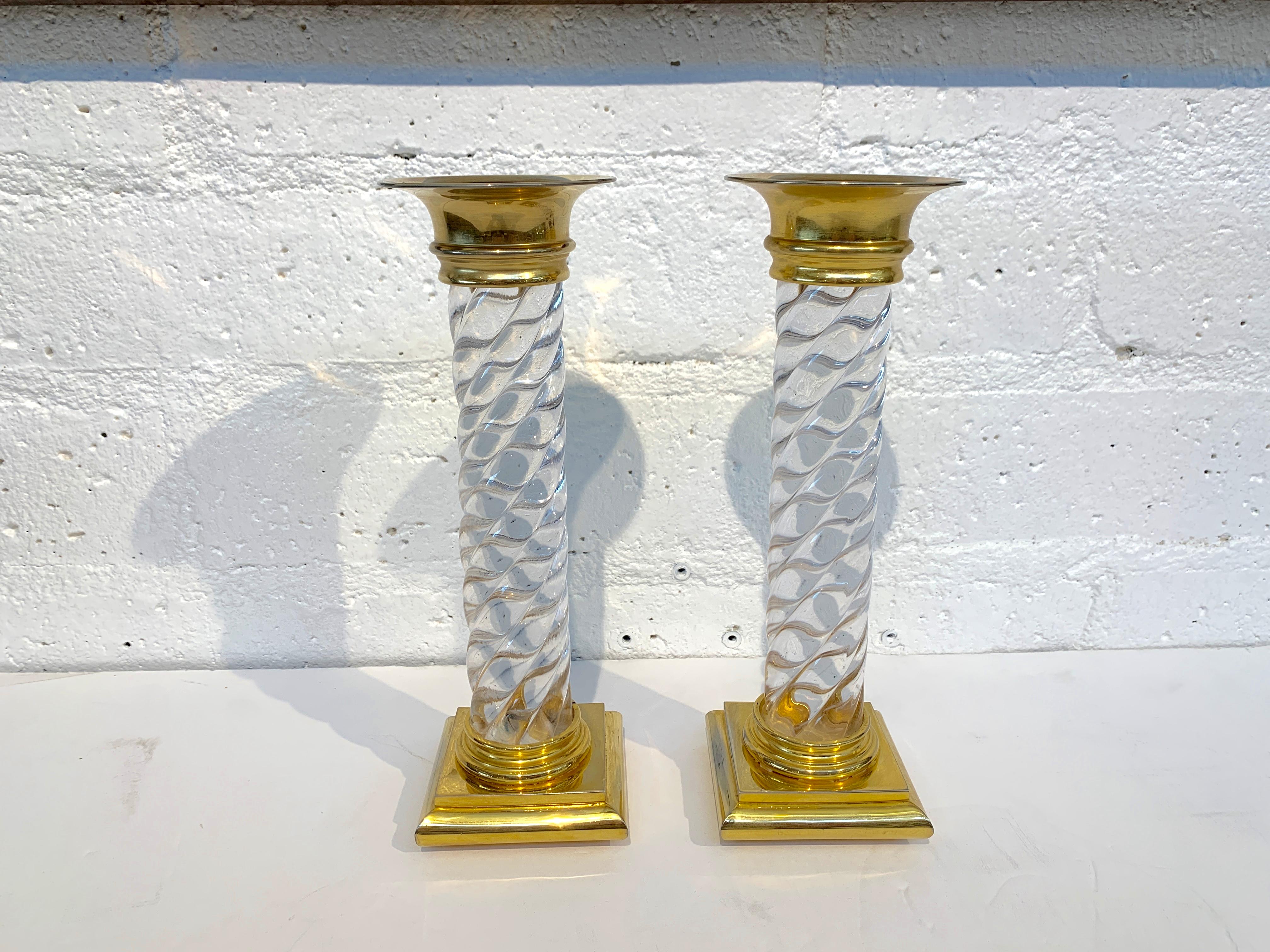 A pretty pair of glass or crystal candlesticks with brass or ormolu mounts. The glass or crystal portions are in good condition the mounts have wear and the interior parts wear the candles go in are scratched, please see the detailed photos. I