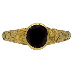 Early gold ring set with garnet, circa 18th century.