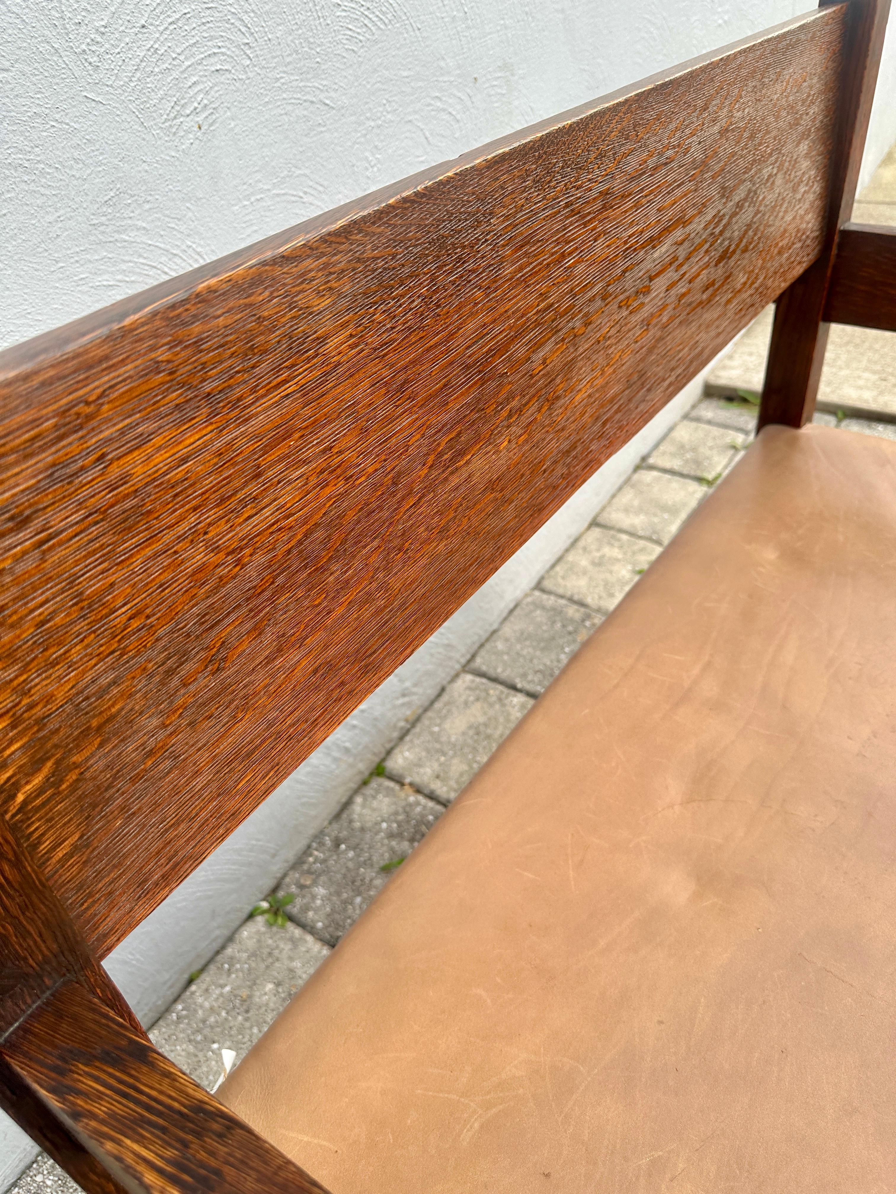 This is an early Gustav Stickley Hall Seat made in 1901. Extremely collectible! Keyed Through Tenon construction on the bottom. Pinned all around. Original leather and tacks. There are some stains on the leather.  The leather seat has been