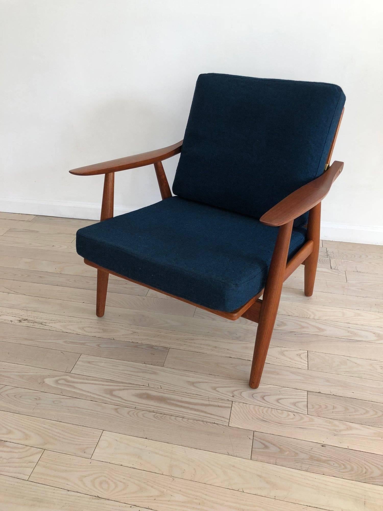 Hans Wegner style GE-270 teak armchair, made in 1956 in Denmark produced by GETAMA, Gedsted Denmark. Teak frame with exposed brass fittings. New memory foam cushion with original wool covers. Iconic and authentic Hans J Werner. Labelled and all