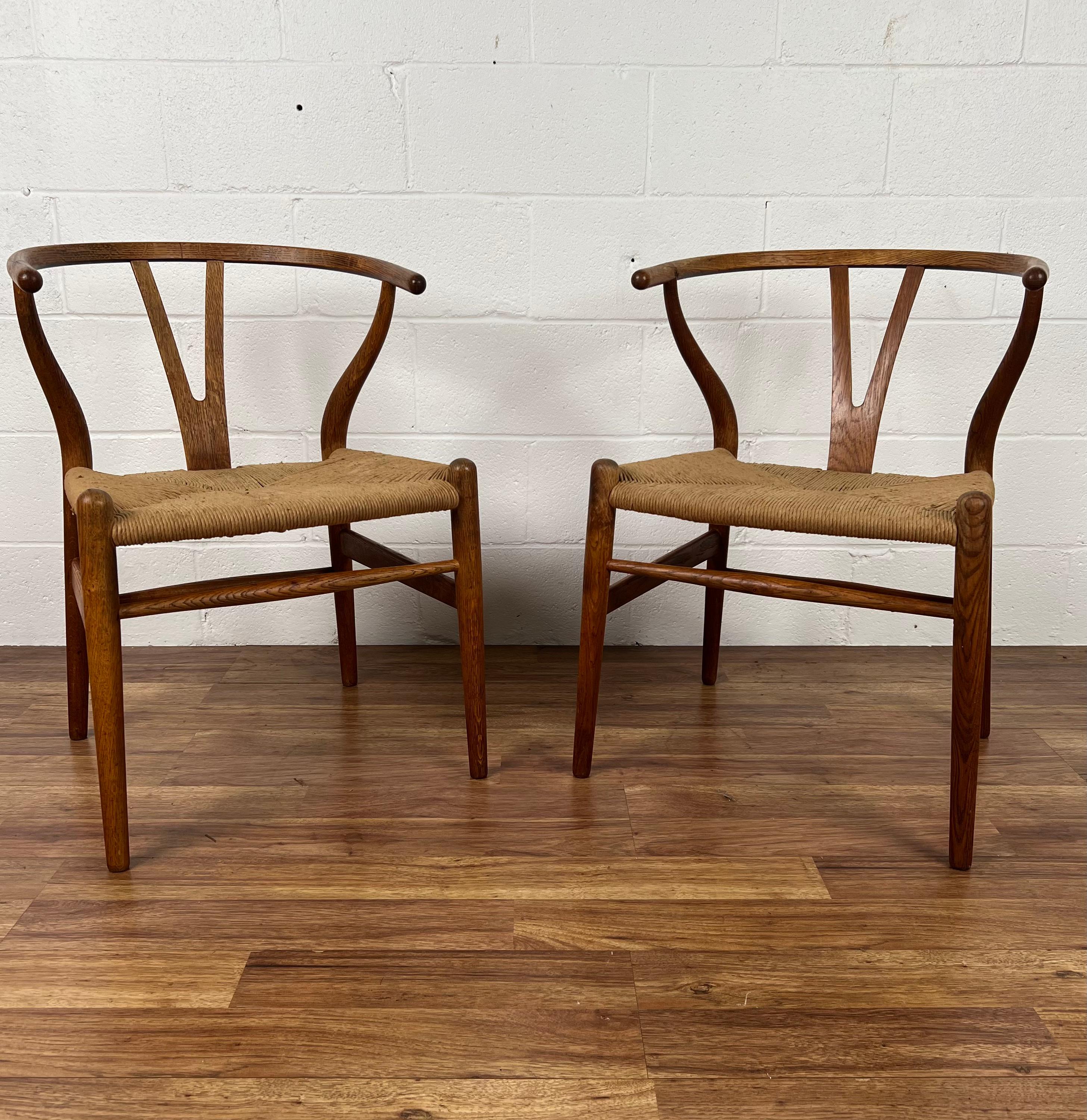 For your consideration we offer this rare and early original matched pair of Hans J. Wegner's iconic CH24 wishbone chairs. These have been the most popular of all of the beautiful pieces made by this legendary designer. This lovely pair was