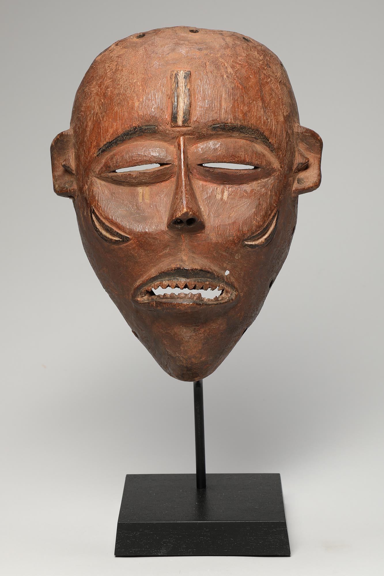 Finely carved hardwood mask from the Pende people of the Democratic Republic of Congo. Expressive, with finely carved open mouth and filed sharpened teeth. Raised scarification marks on forehead and cheeks. Small hole by mouth where the sculptor who