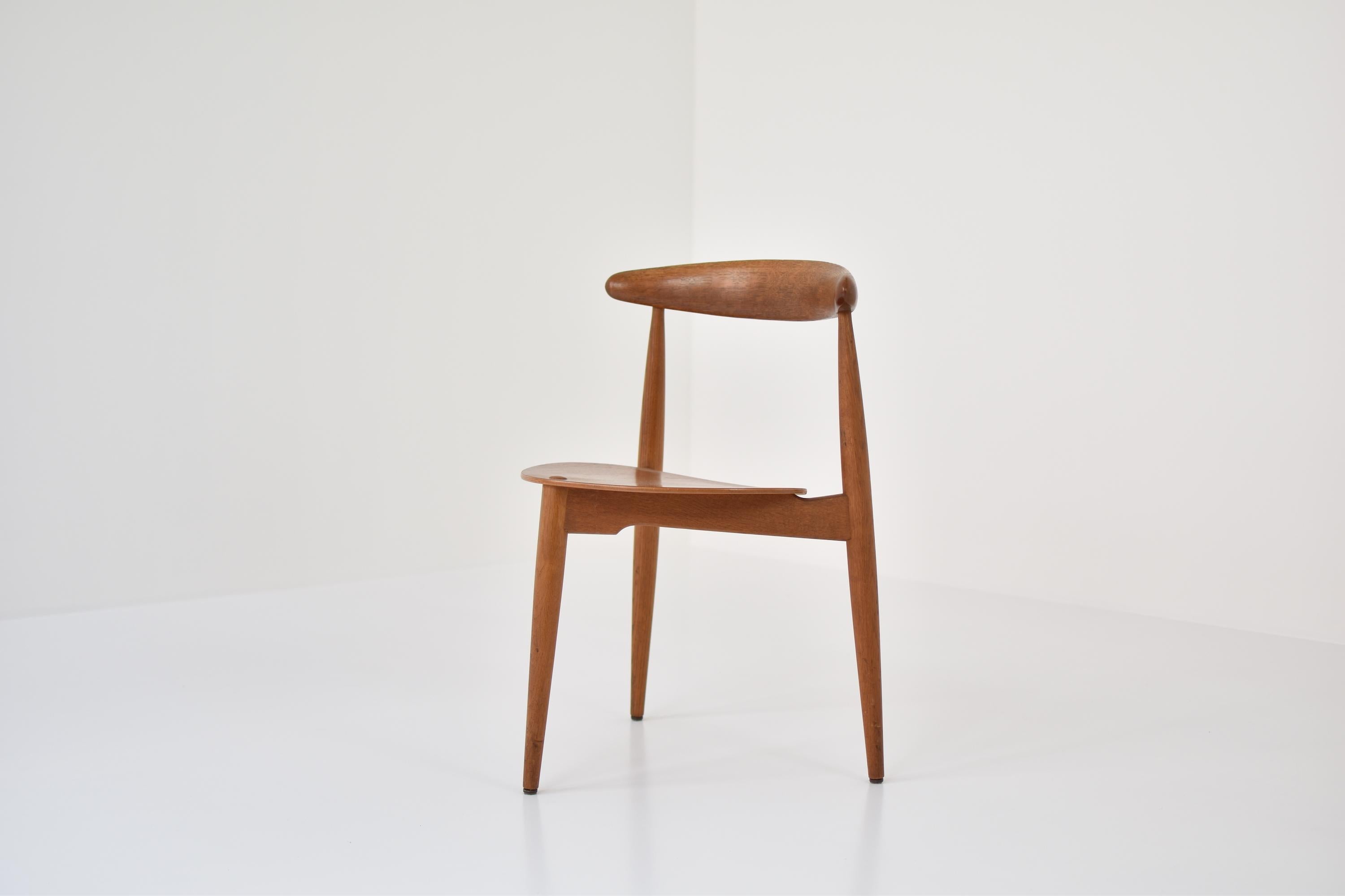 Lovely ‘Heart’ side chair designed by Hans J. Wegner and produced by Fritz Hansen, Denmark, 1952. This architectural piece of art has a tripod base and a seating made out of teak finished with a solid backrest. This is model FH 4103, also called the