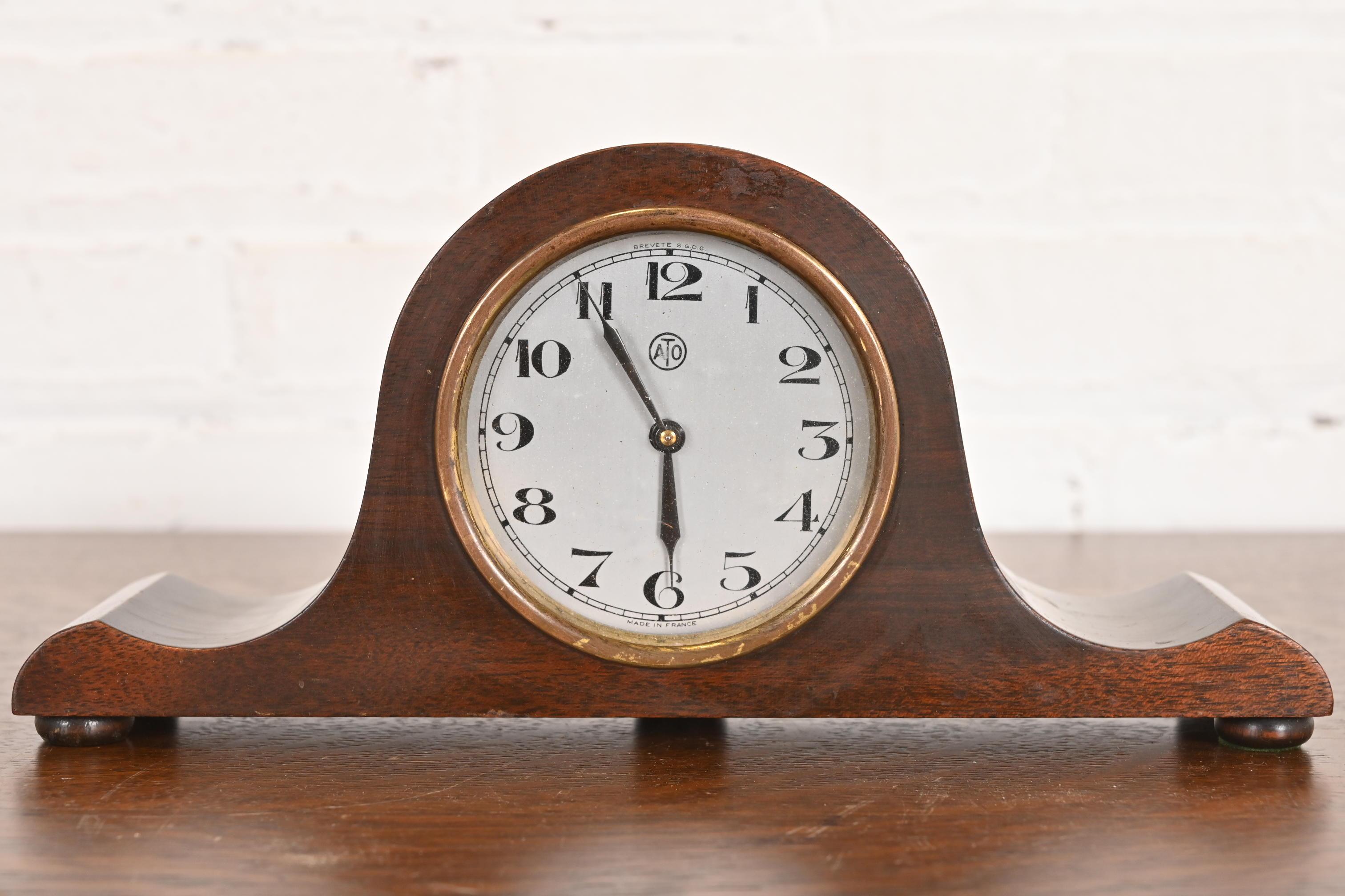 A gorgeous and rare Art Deco period mahogany mantel clock

Produced by ATO for Herman Miller 

France, Circa 1930s

Measures: 11