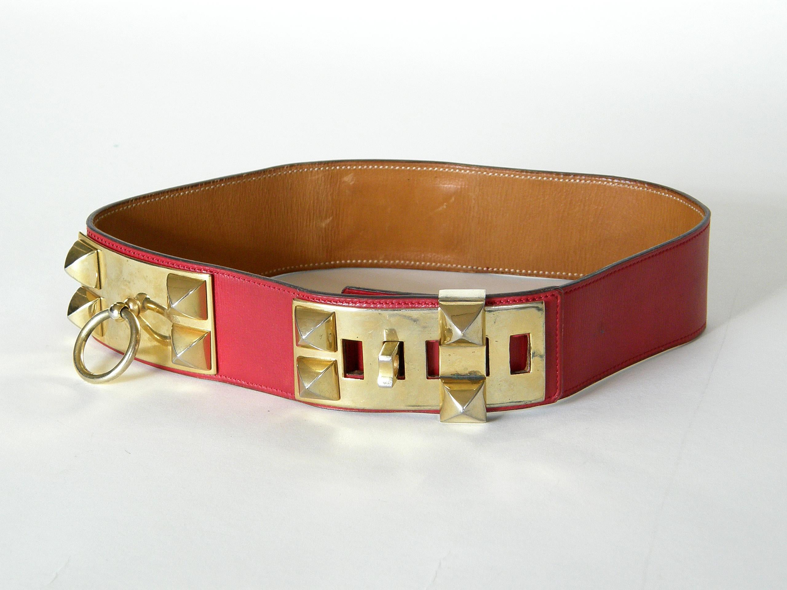 This iconic Hermès Collier de Chien belt is made of lipstick red leather with gold plated hardware. This classic design was adapted from a custom designed dog collar made for a private client of Hermès in 1923. Due to the popularity of the design,