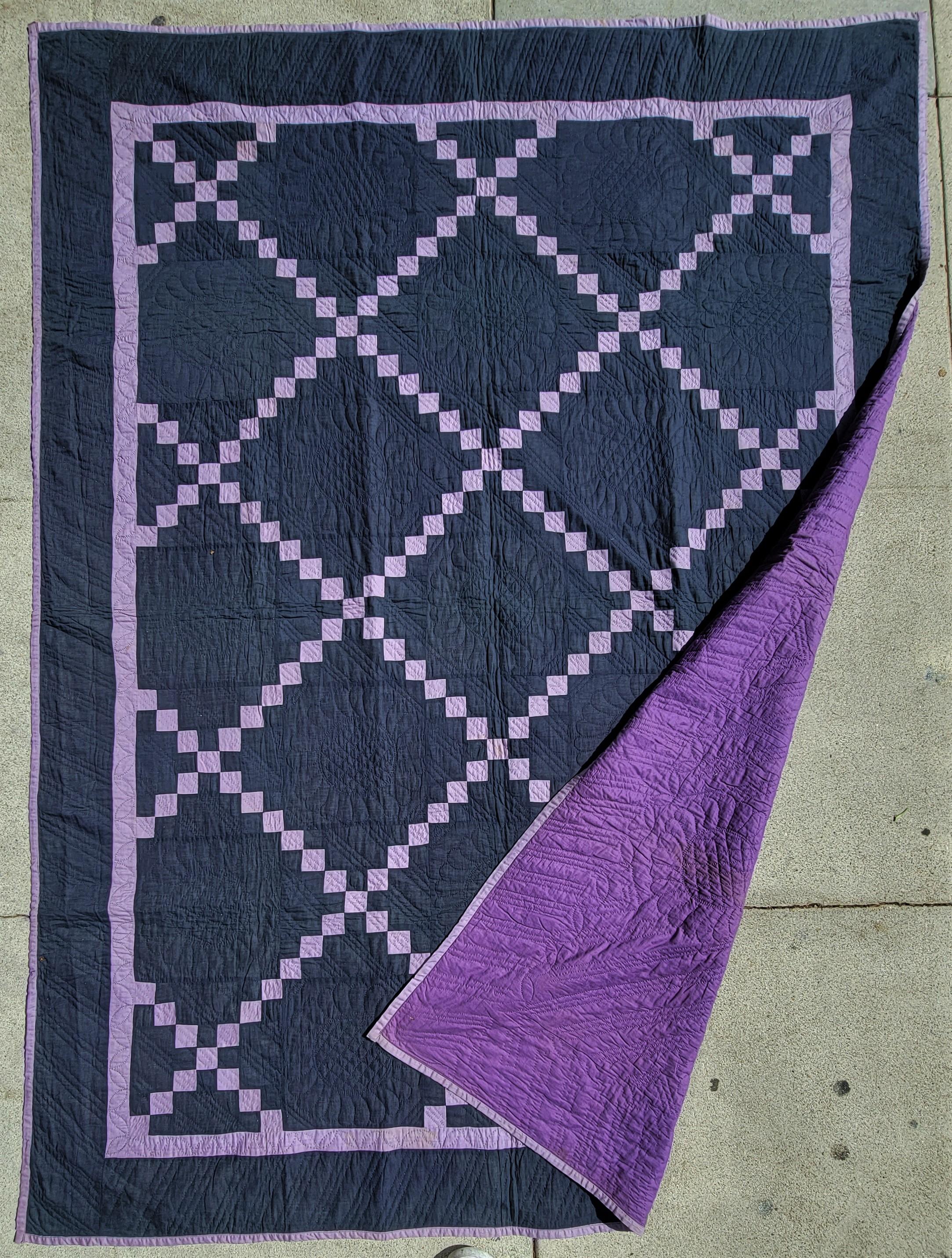 Early 20Thc Amish Holmes County ,Ohio postage Irish chain  quilt in pristine condition. This amazing blue back round quilt has a purple Irish chain trail.The backing is in an amazing purple backing.