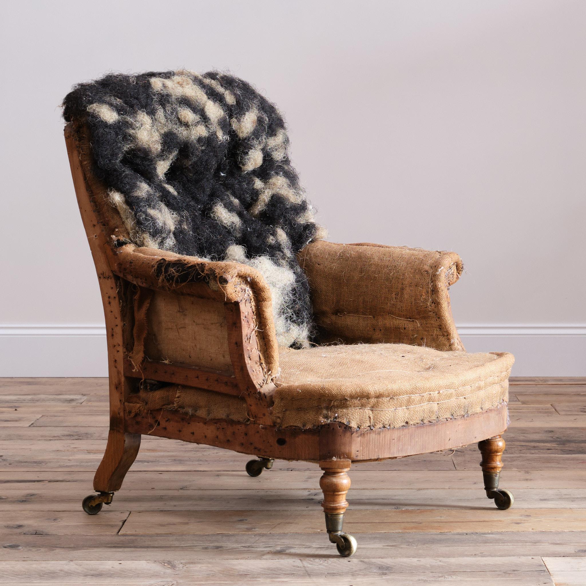 A wonderfully shaped mid 19th century Howard & Sons 'Hammond' armchair. The walnut frame raised on turned legs and all with the original Cope & Collinson worn gilt brass casters.  The right back leg bearing the early serial number. 

A good solid
