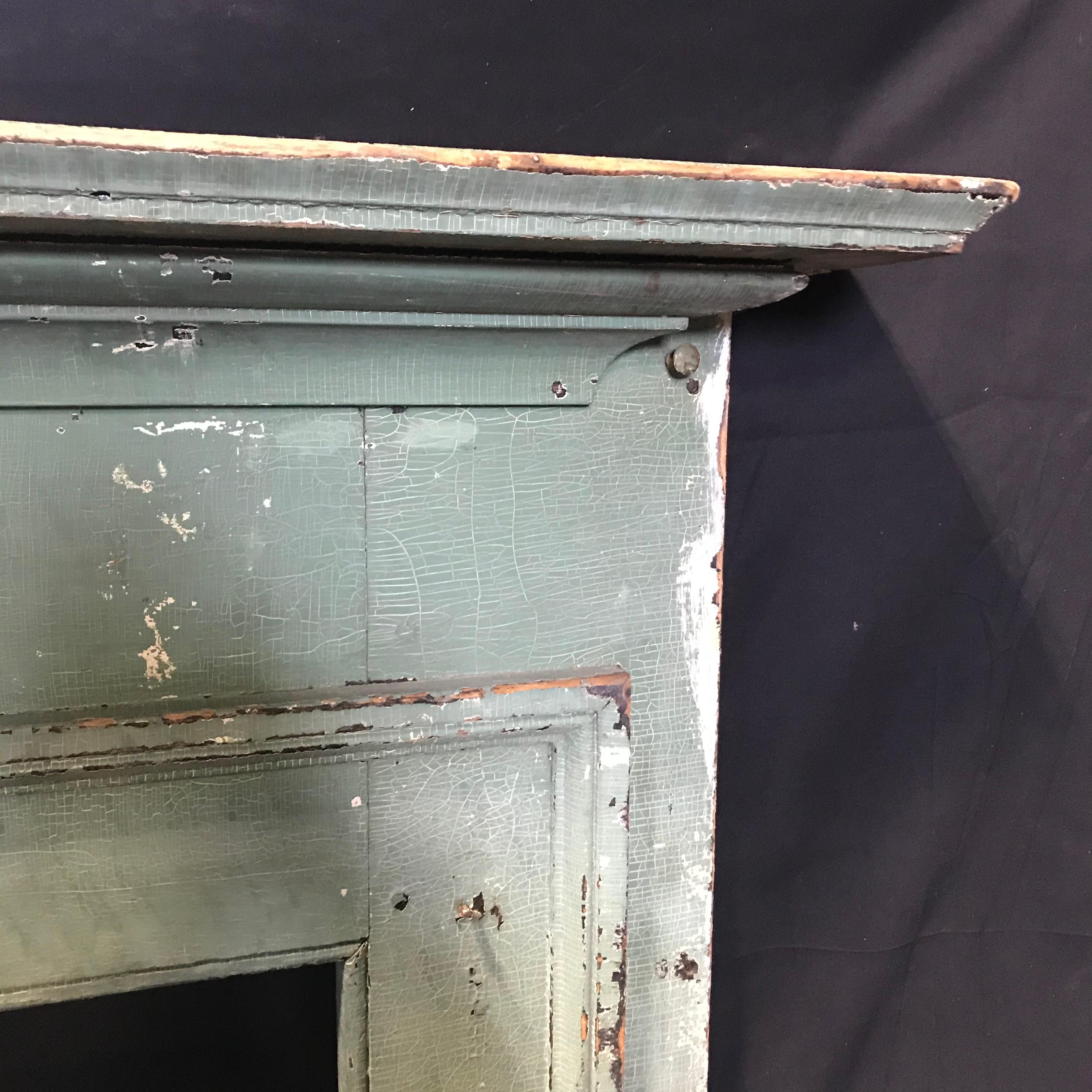 Early most likely 18th century country Federal fireplace mantel with chippy original pale green paint and three plank back. 
Opening 42.75” H x 52.75