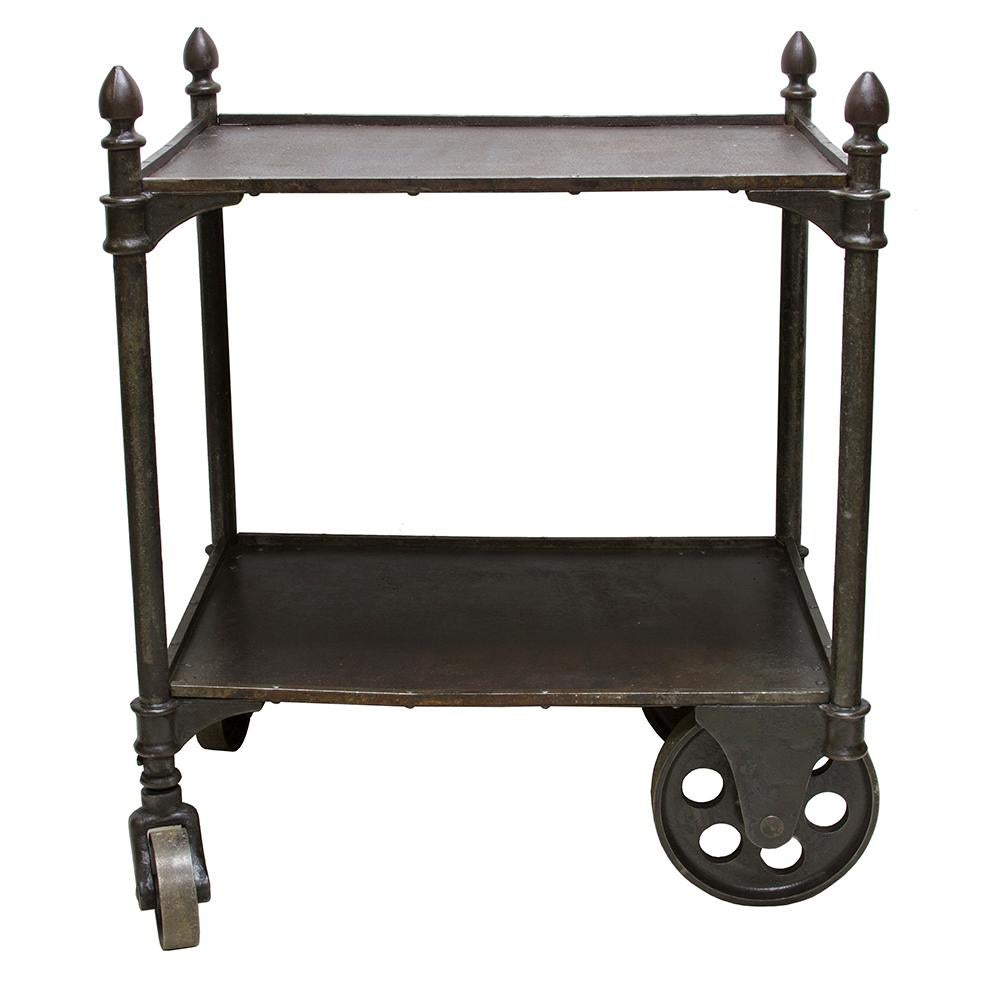 This solid cast iron cart is an excellent example of the style and substance of late 19th century Industrial factory fixtures. Every piece of this cart is individually cast and has the added style of an acorn finial at each corner. The smaller