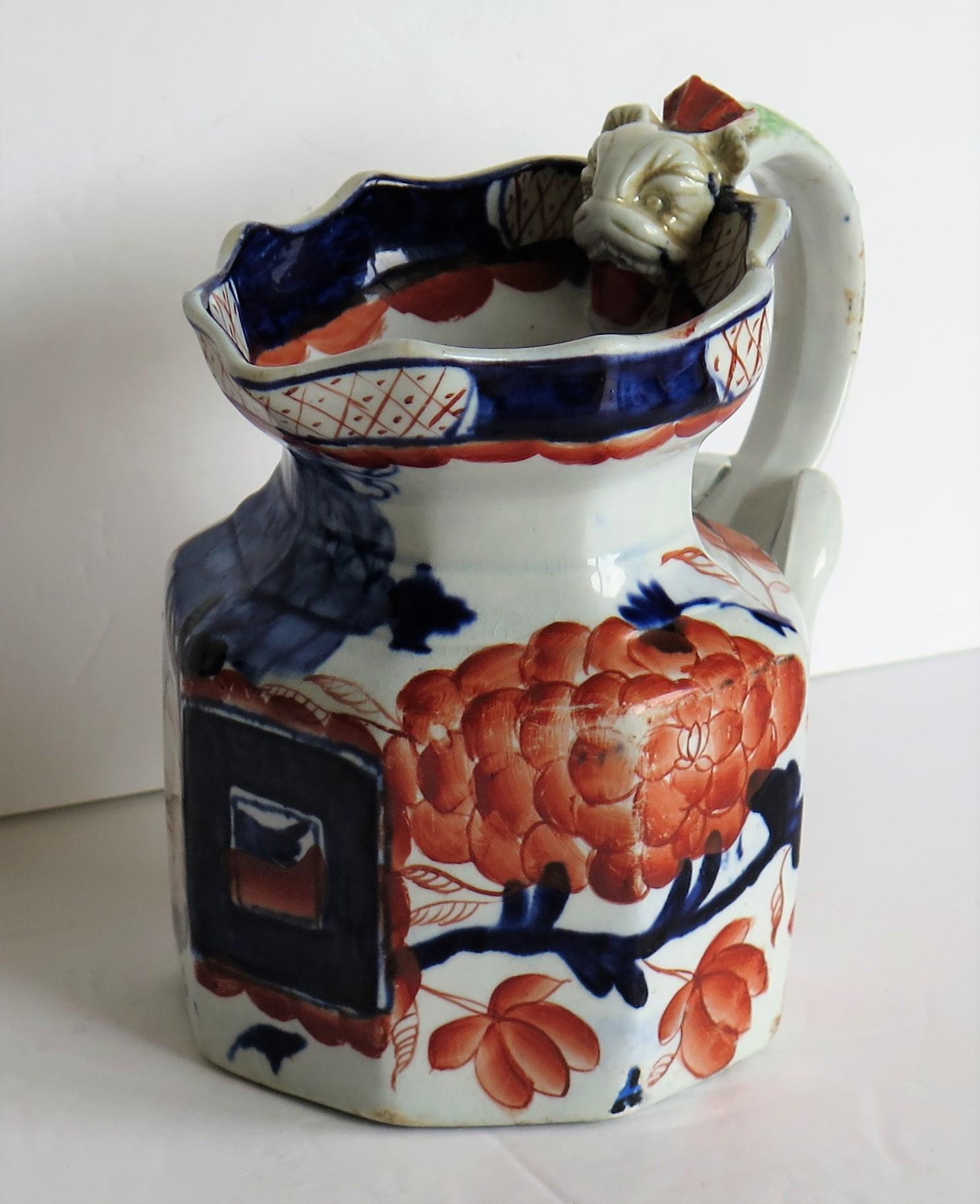 This is a good early 19th century ironstone jug or pitcher, all hand painted and made by one of the English Staffordshire Potteries in the late Georgian period, circa 1820.

The jug is octagonal in shape with a good dragon shaped loop handle, very